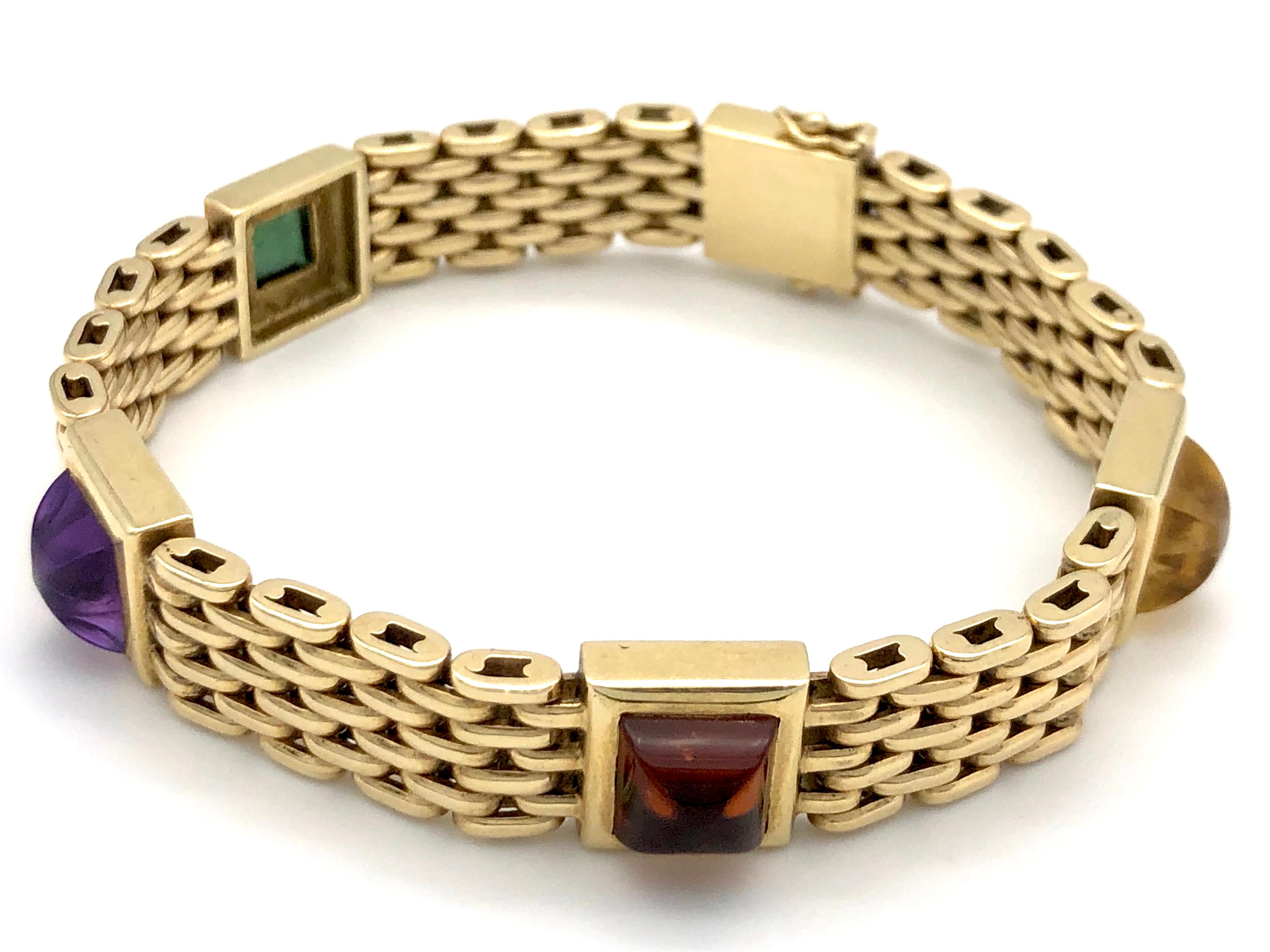 The 14K gold gate bracelet is set with an amethyst, a tourmaline, an aquamarine and two citrines in sugarloaf cut. The bracelet shows the makers mark 