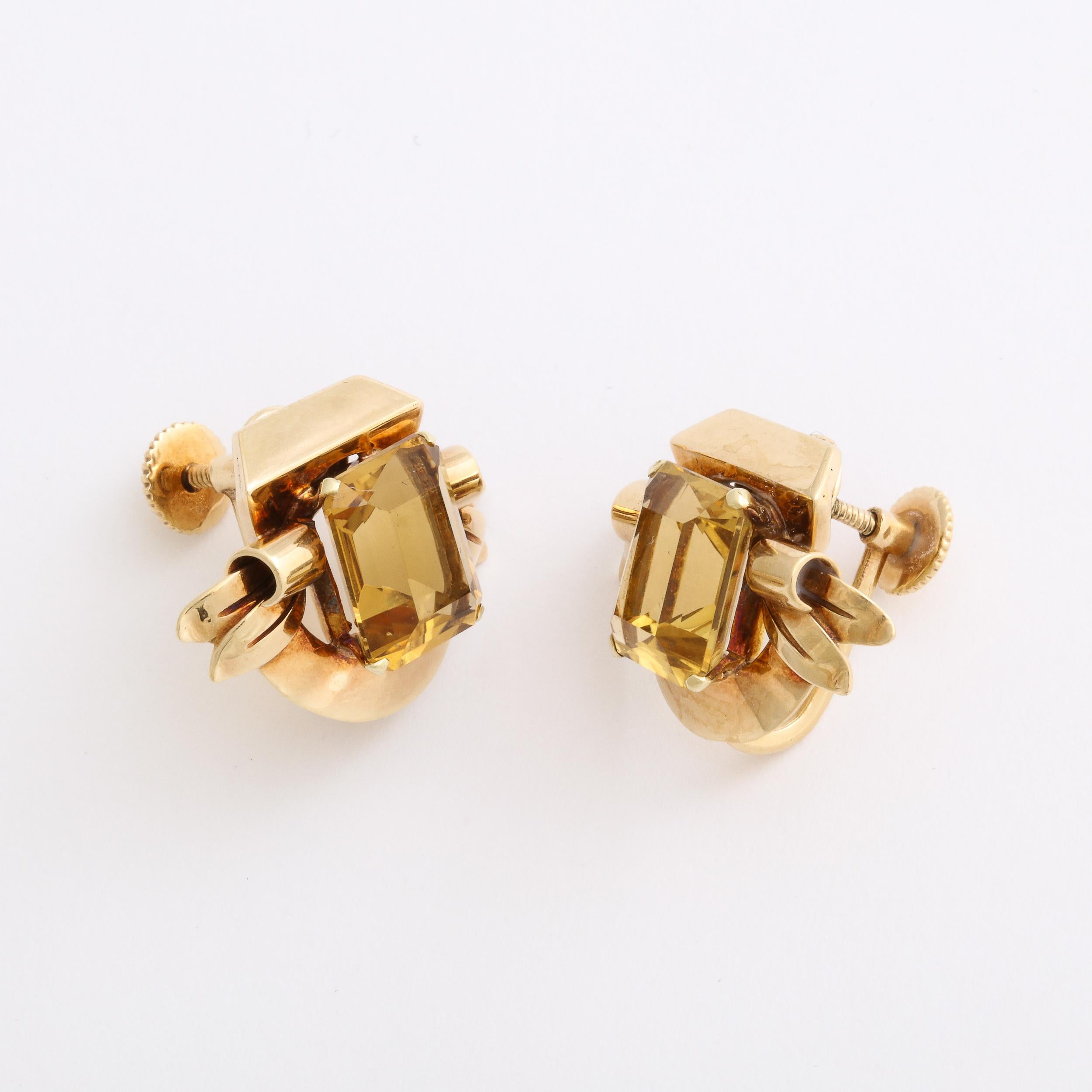 These Art Deco Retro 14ct. Yellow Gold & Citrine Earrings Signed Cartier originate from France, Circa 1935. They feature stepped Emerald Cut Citrines nested in four pronged attachments accented with a sophisticated combination of geometric and