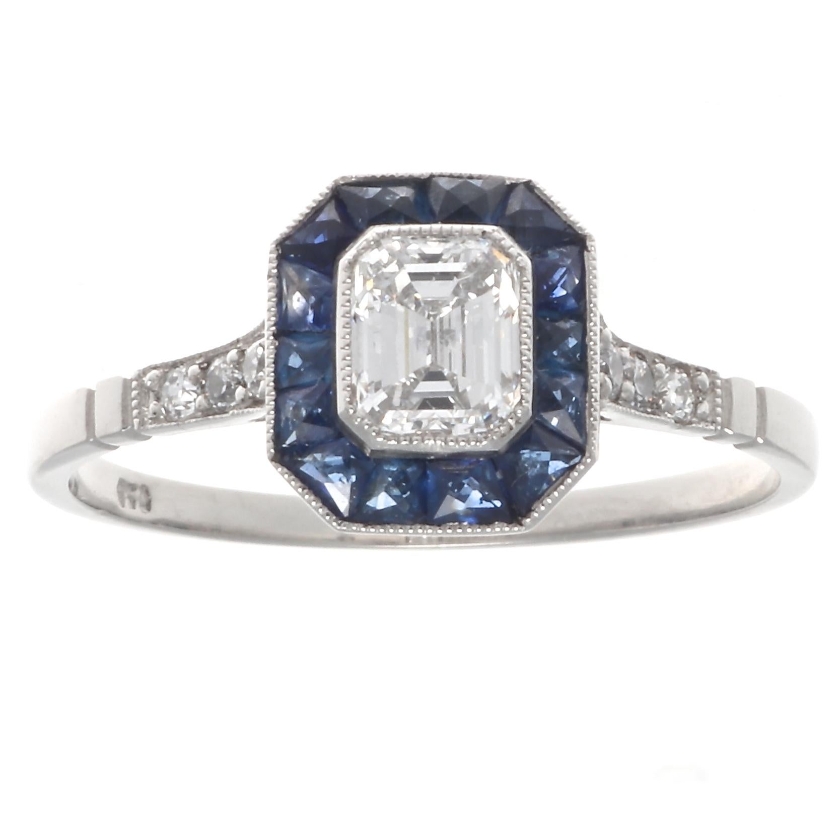 Art Deco inspired 0.48 carat diamond platinum ring. Featuring an emerald cut diamond graded E-F color, VS clarity. With 14 French cut sapphires that weigh approximately 0.70 carats. And 6 old European cut accenting diamonds graded as H-I color, VS