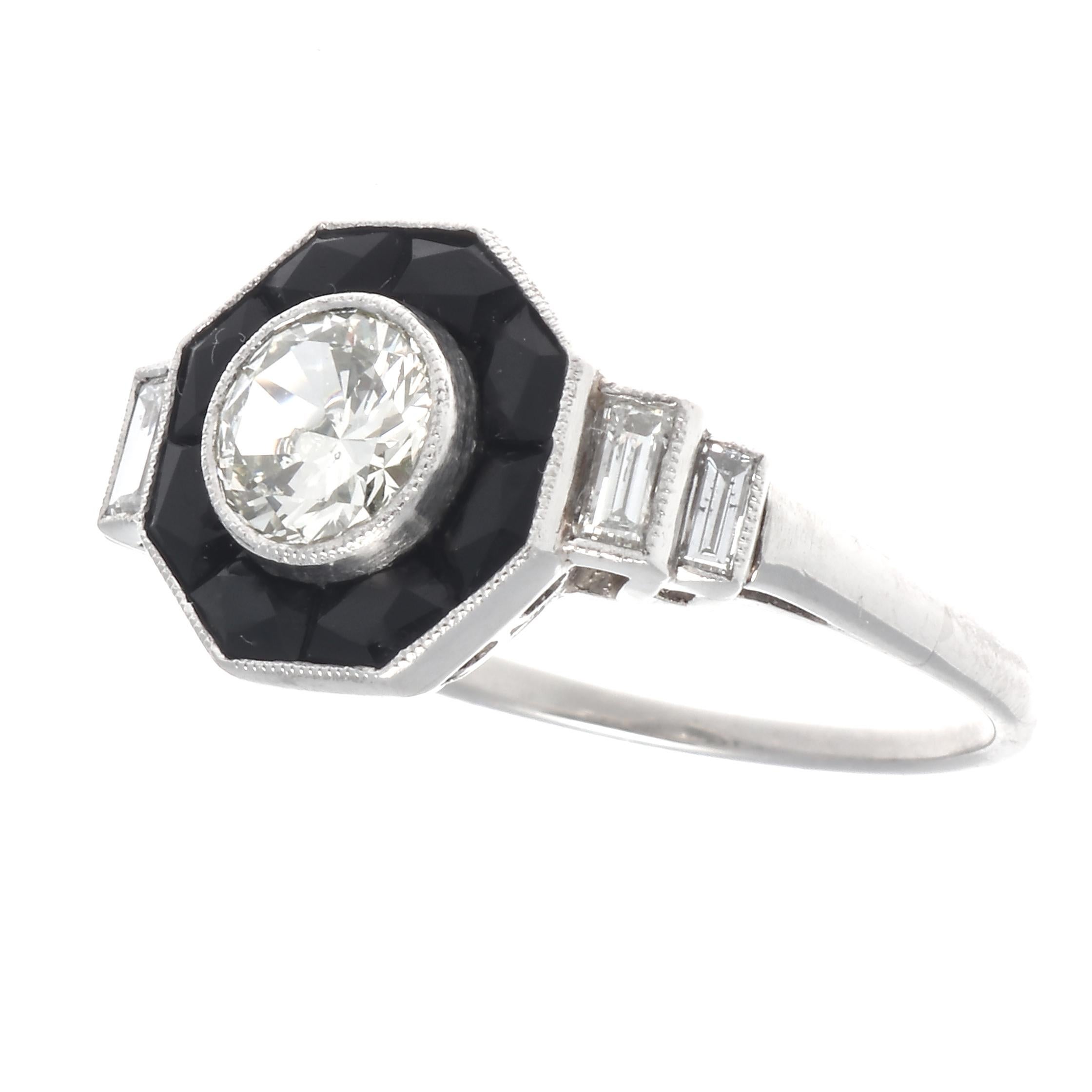 Art Deco inspired diamond platinum ring. Featuring a 0.50 carat transitional cut diamond, graded I-J color, SI2 clarity. With 4 accenting baguette cut diamonds that weigh 0.35 carats, graded G-H color, SI clarity. And 8 French cut onyx that weigh