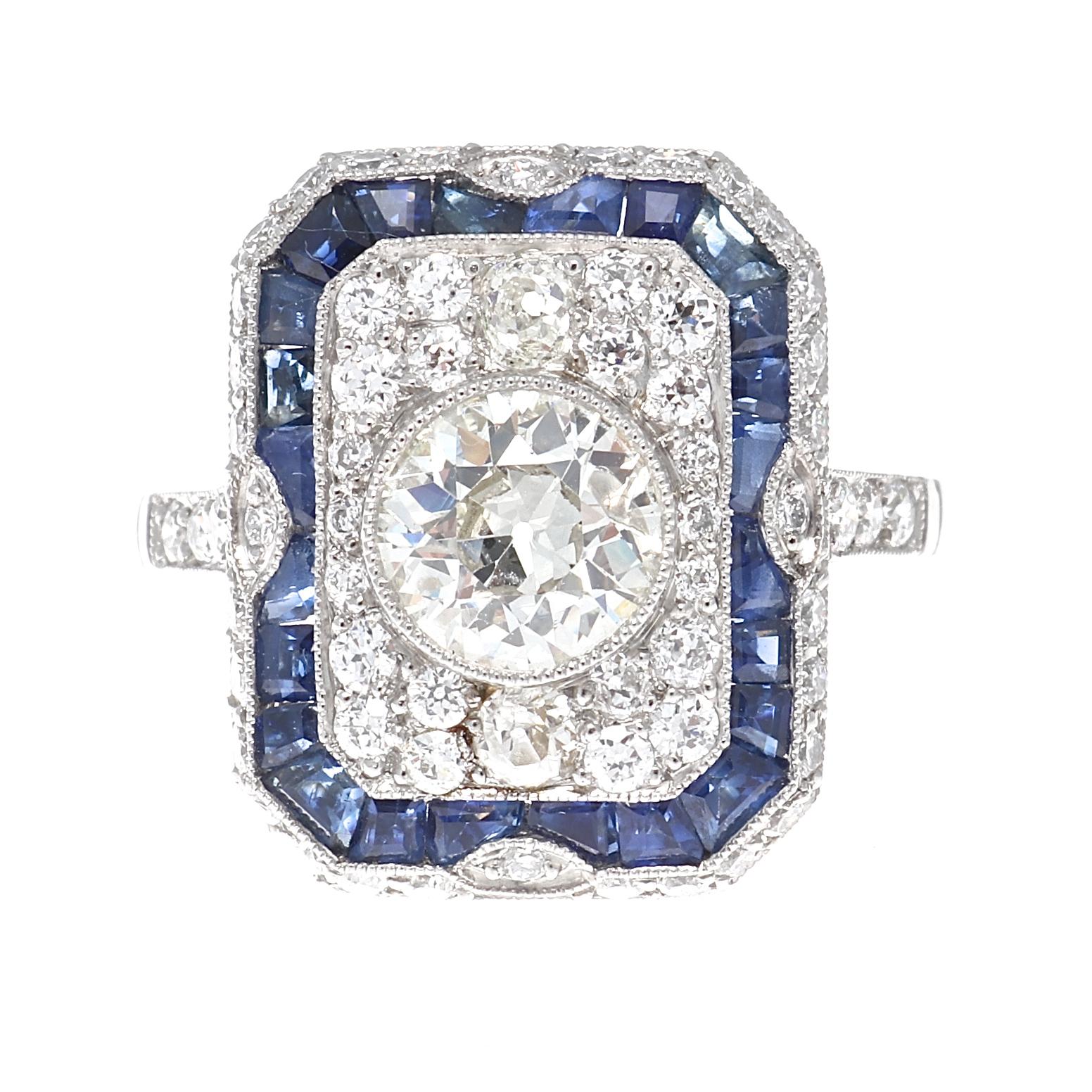 A burst of brilliance through geometric design and dazzling gemstones. Featuring a 1.01 carat old European cut diamond that is approximately L color, SI clarity. Surrounded by a treasure trove of near colorless diamonds and a splash of navy blue