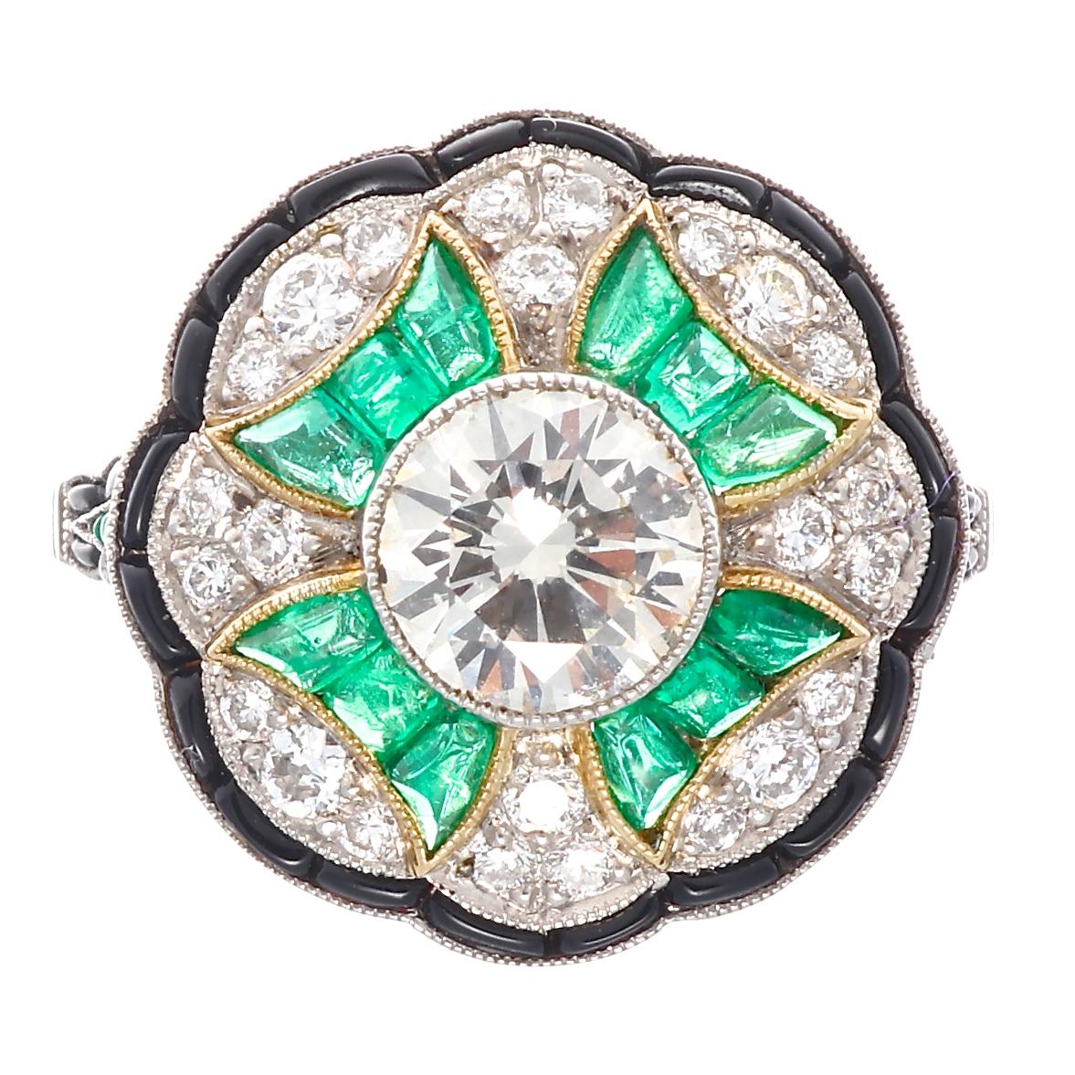 A perfect representation of the style of the lavish Art Deco time period. Featuring a 1.12 carat transitional cut diamond that is approximately J color, VS2 clarity. Accented by an exploding bouquet of color that is designed with vibrant green