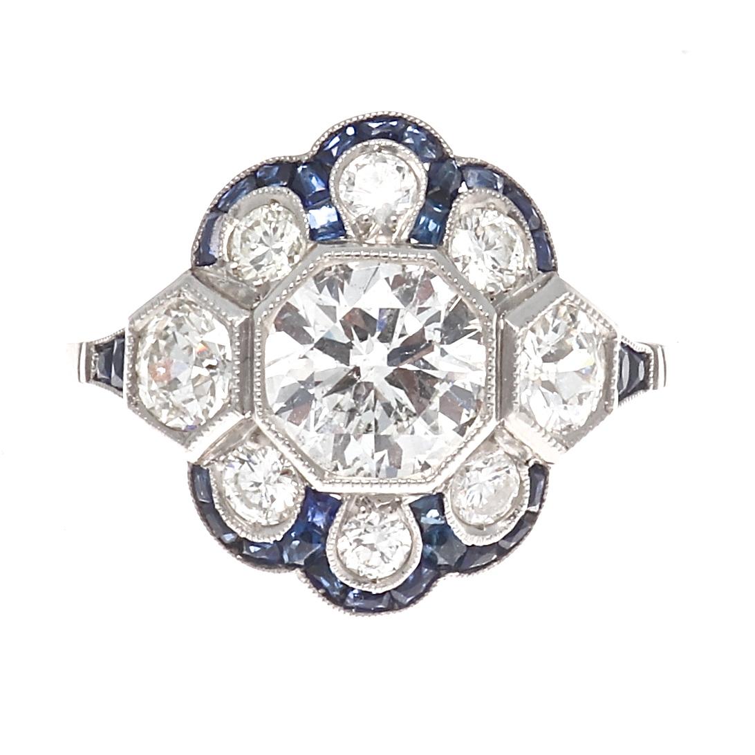 Everlasting beauty symbolizing eternal love through a forever blossoming flower. The perfect ring to grow old with. Featuring a 1.13 carat diamond that is approximately H color, SI clarity. Supported elegantly by near colorless diamonds and navy