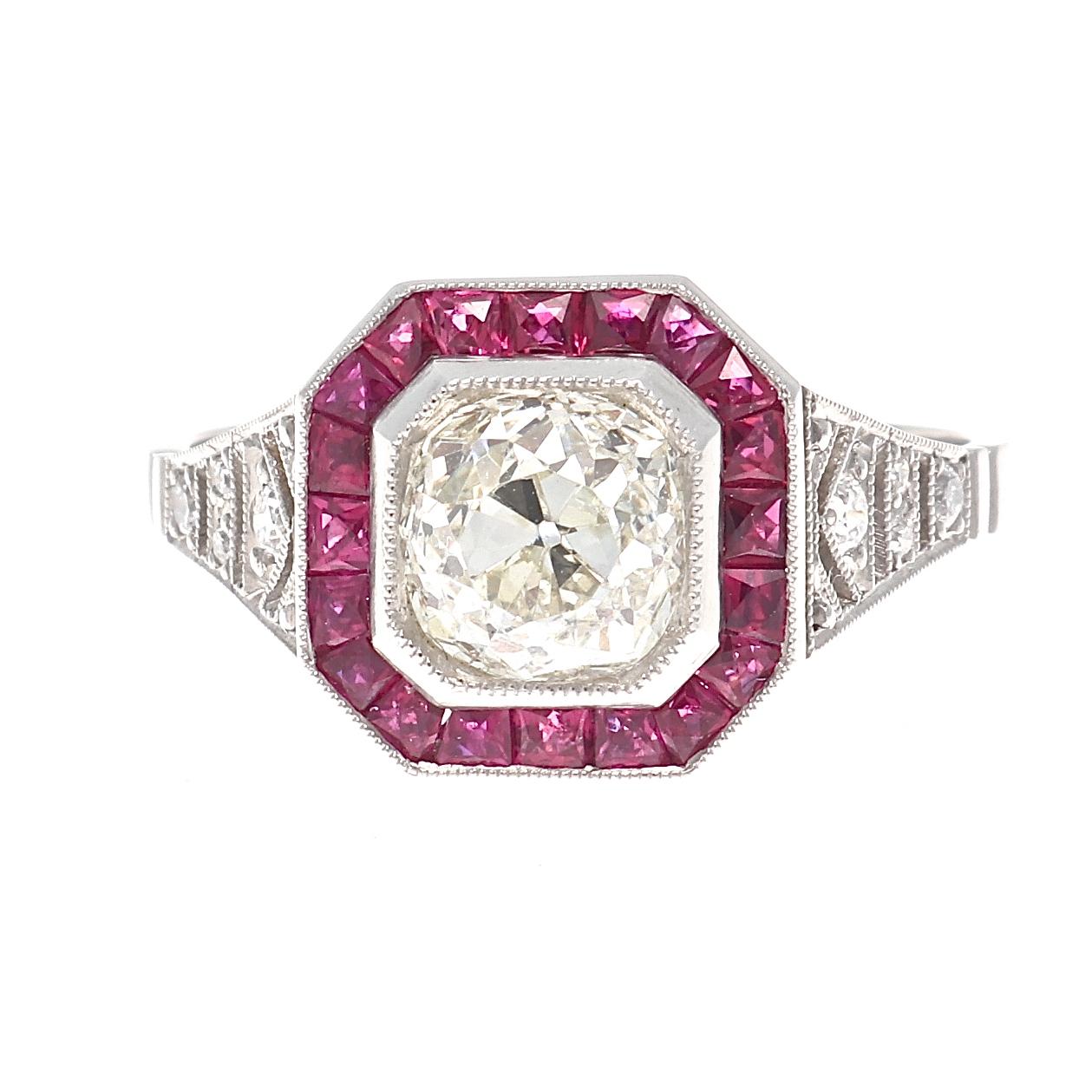 Tradition and design that will last a lifetime. Featuring a 1.25 carat old European cut diamond that is approximately M color, VS1 clarity. Surrounded by a halo of radiating red rubies. Crafted in platinum. Ring size 6-3/4 and can easily be resized