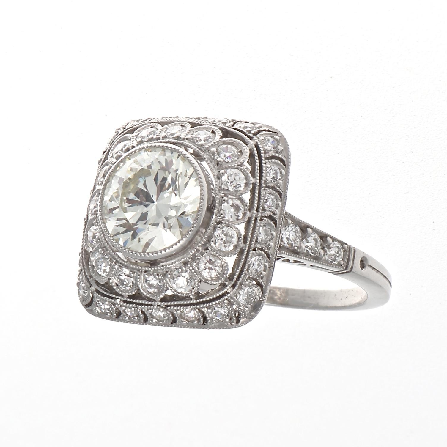 Elaborate design bringing the roaring 20s to your finger for everyone to view and admire. Featuring a 1.43 carat old European cut diamond that is approximately M color, VS1 clarity. Surrounded by a a dome of floating halos designed with near