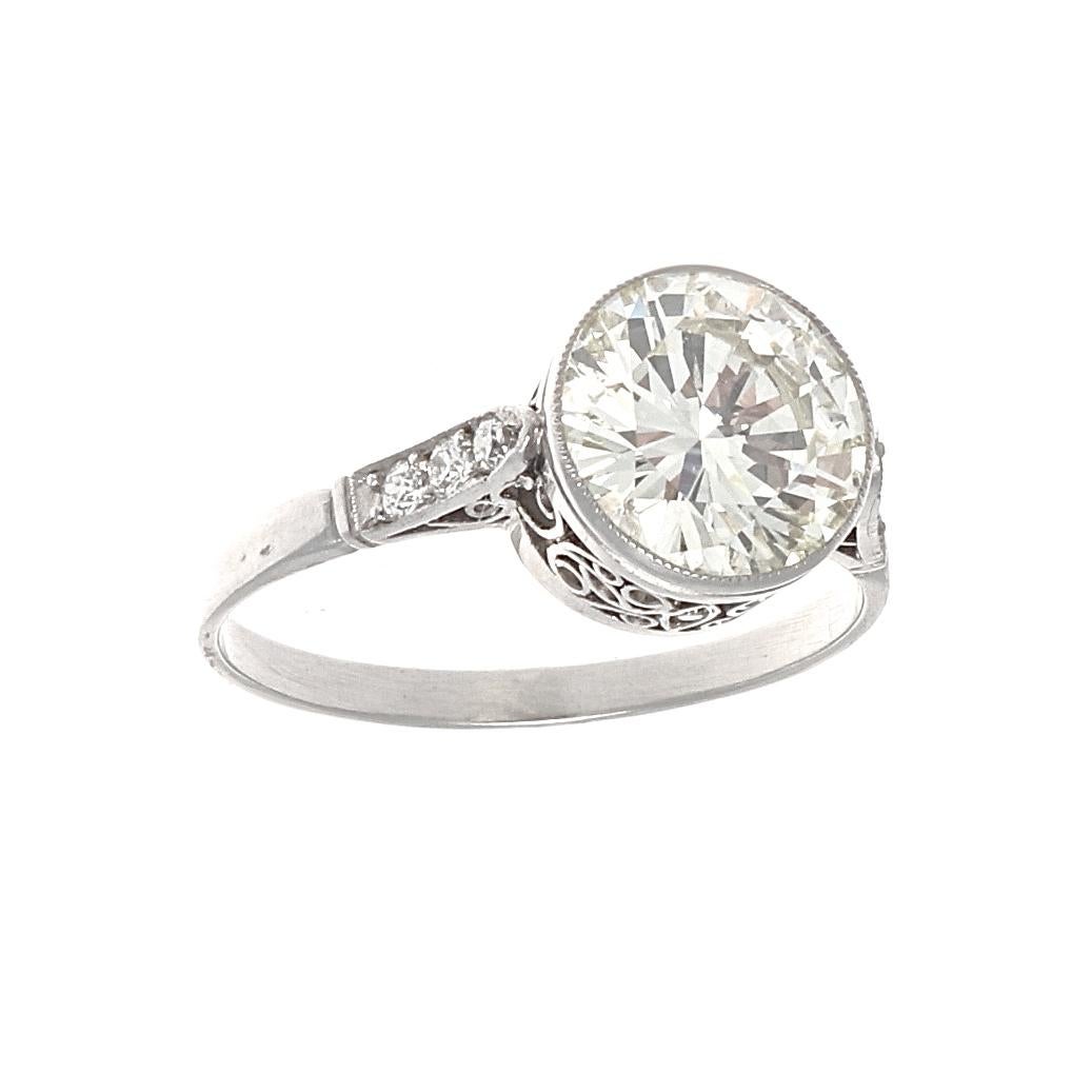 Everlasting beauty symbolizing eternal love. The perfect ring to create memories and grow old with. Featuring a 2.01 carat old European cut diamond that is M color, VS clarity. Accented by numerous near colorless diamonds and elegantly decorated
