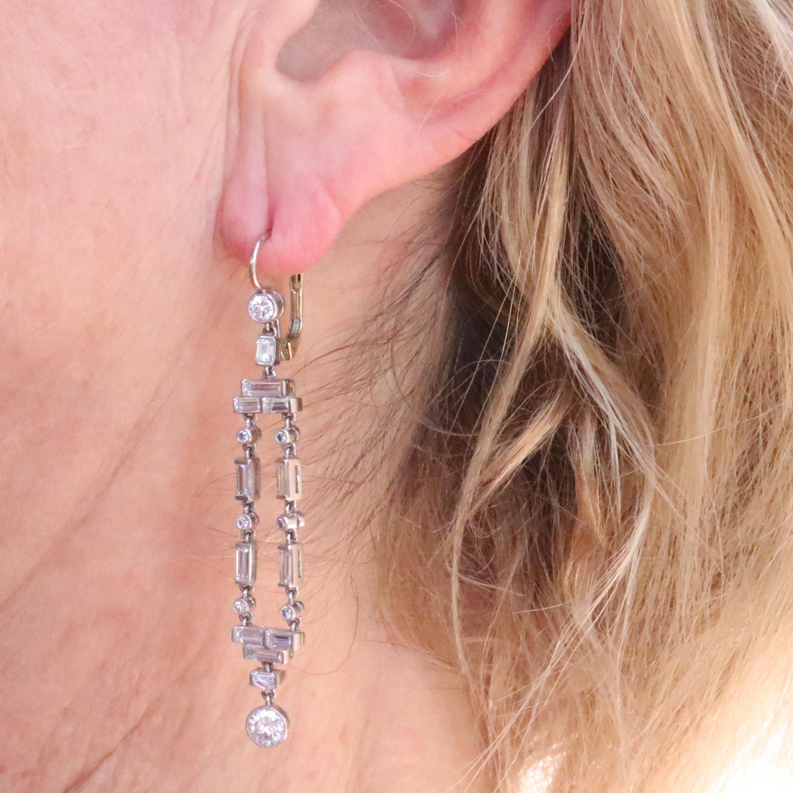 Art deco inspired earrings featuring approximately 3 carats of diamonds. 2 old European cut diamonds drops weigh approximately 0.70 carats total, graded G-H color, VS clarity. The top features 2 old European cut diamonds that weigh approximately