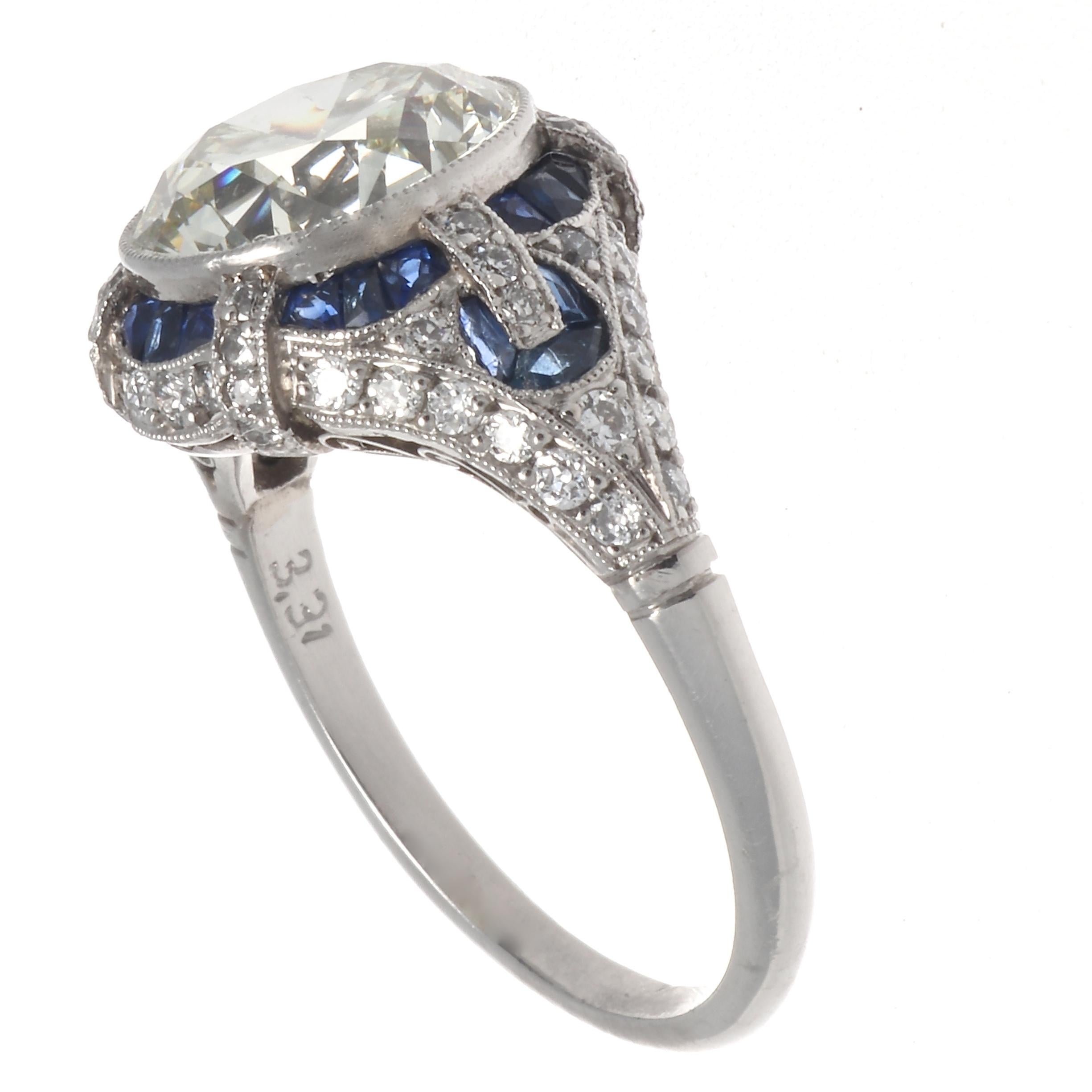 A colorful and substantial engagement ring, inspired  from the Art Deco era. Reflecting the elements of that time in symmetry, elegance, grace and beauty.  Featuring a 3.31 carat old European cut diamond, graded as K,L color, VVS clarity. With 24