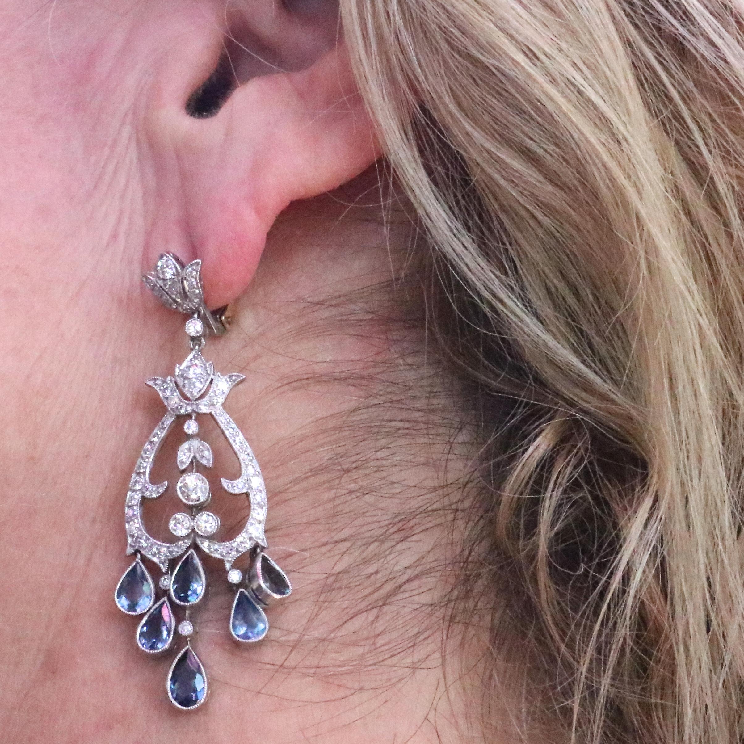 Art deco inspired aquamarine diamond platinum chandelier earrings. Featuring 12 faceted teardrop shape aquamarines that weigh approximately 4.20 carats. With 114 mostly old European cut diamonds, with a few single cut diamonds all weighing