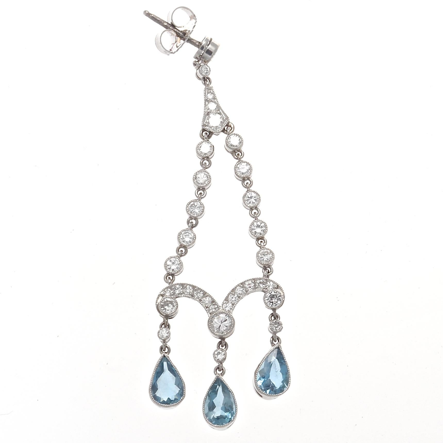 Elegant bliss, bringing the golden era of jewelry to life. Featuring chandeliers of aquamarine and diamonds. Crafted in platinum. 2-1/4 inches long.