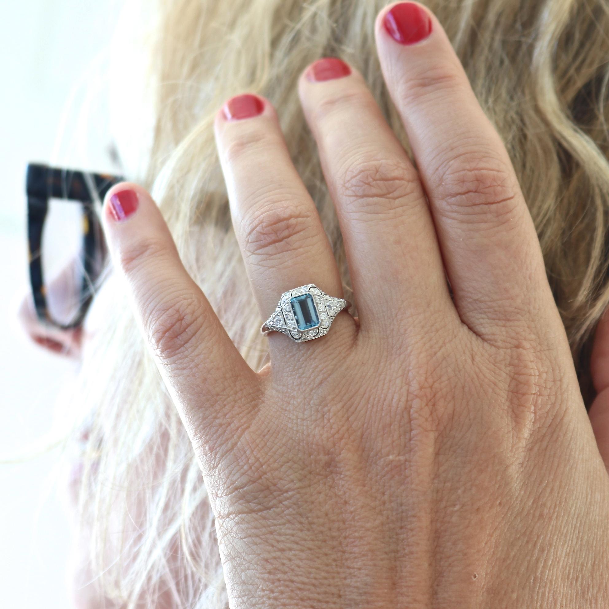 Intricacy made in loving fashion. Featuring a lively emerald cut aquamarine wrapped in sparkling white diamonds and delicately crafted platinum. Ring size 6-1/2 and can easily be resized to fit, if needed this would come complimentary with your