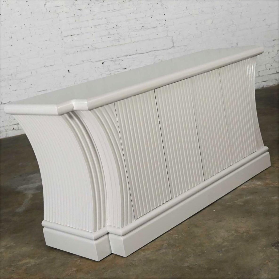 Gorgeous Art Deco Revival custom made fluted off-white/oyster gray color console cabinet buffet comprised of hardwoods, MDF, and black painted inner shelf. Beautiful condition, keeping in mind that this is vintage and not new so will have signs of