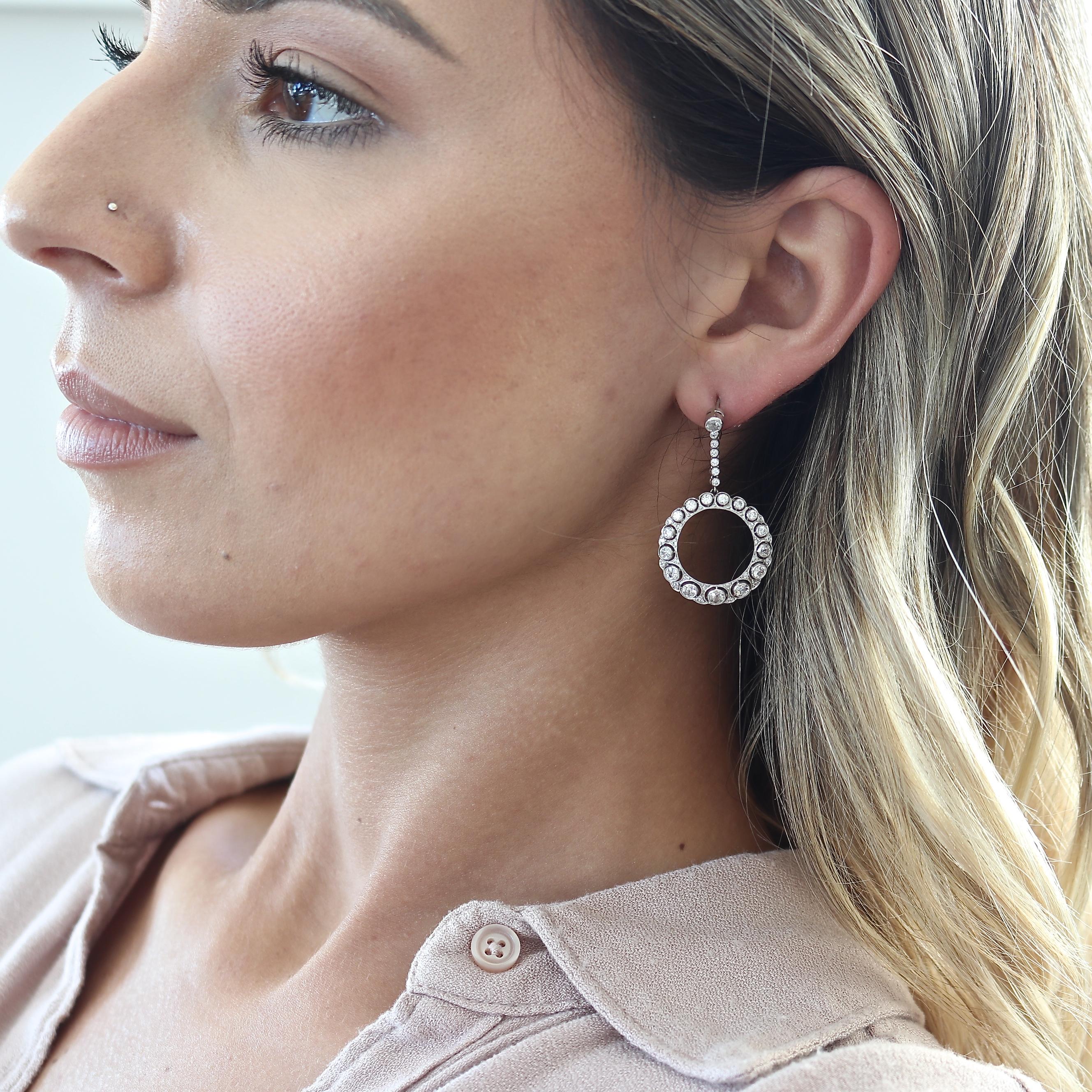 Effortless style that embraces all attire. Featuring numerous old cut diamonds assembled into swooping hoops. Crated in platinum. 1-1/2 inches long.