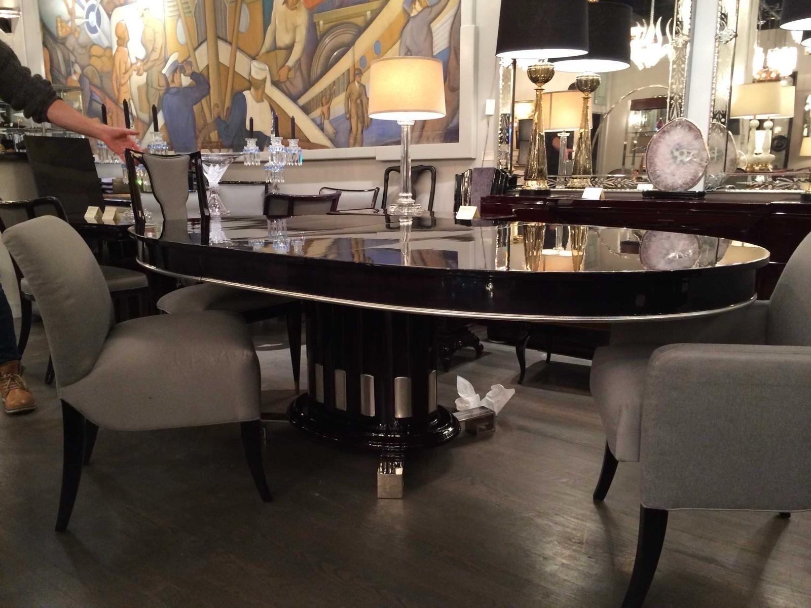 Art Deco Revival Ebonized Dining Table by Renzo Rutili for Johnson Furniture, c. 1940.
Highly Stylized Dining Table in Ebonized Mahogany with silver leaf details. Table has fluted column base design and nickeled bronze greek key motif feet. Table