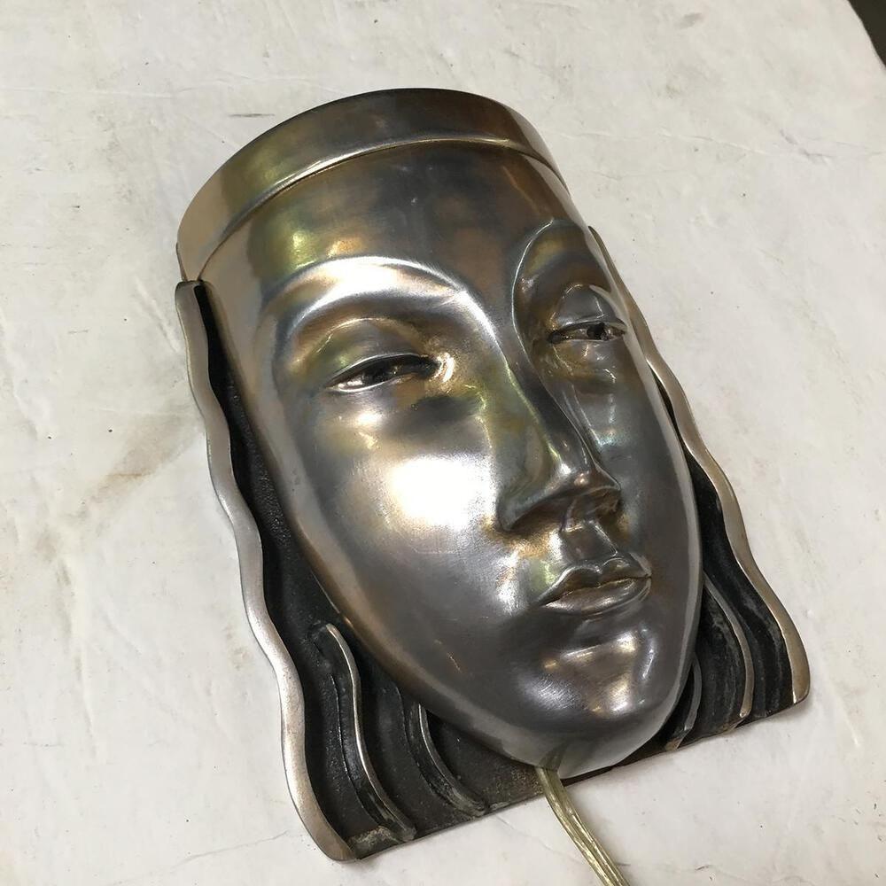 Original pair of Art Deco female face mask wall sconces with a signature on the back marked 