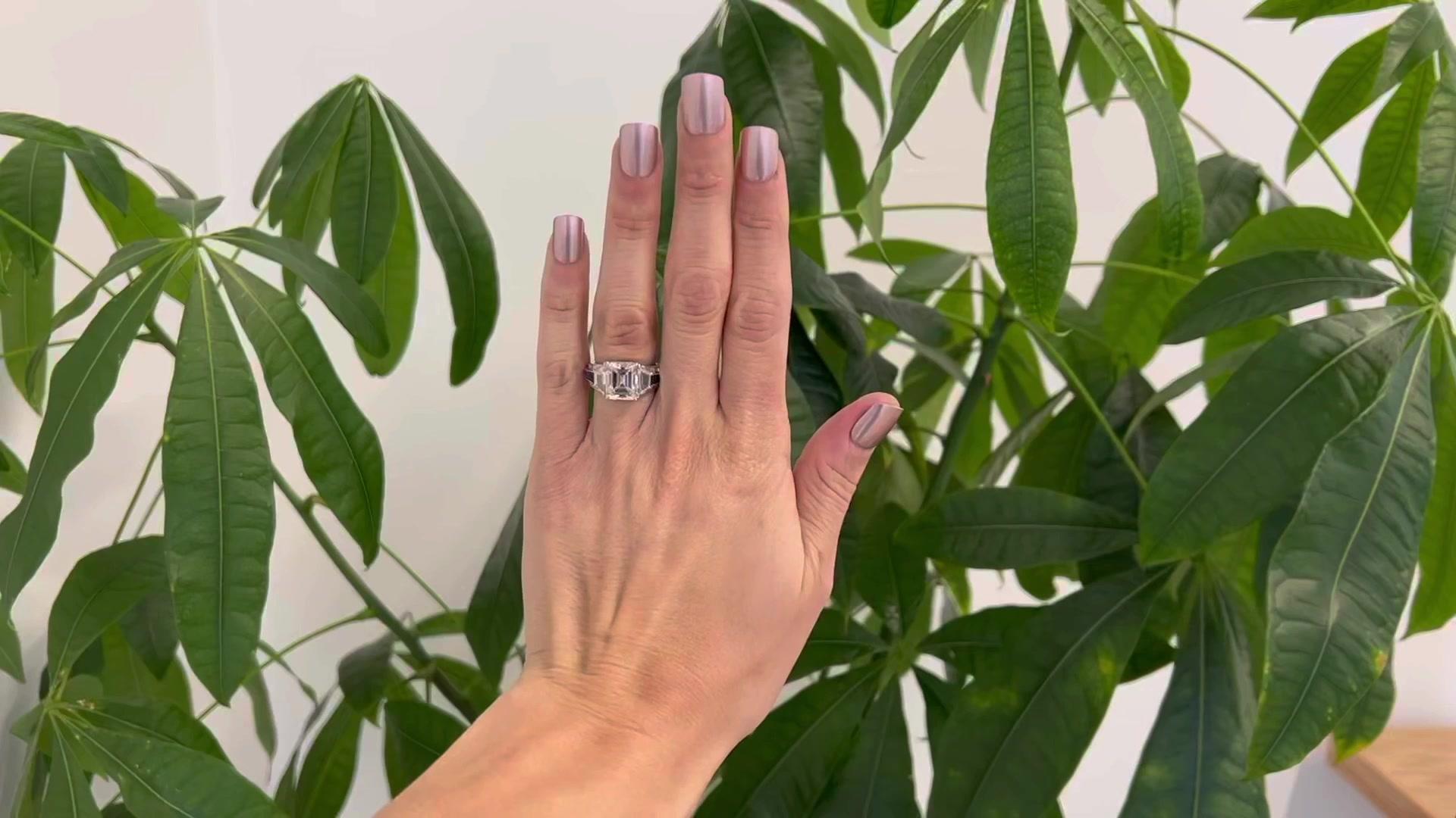 One Vintage GIA 4.61 Carat  Emerald Cut Diamond Sapphire Platinum Ring. Featuring one GIA emerald cut diamond of 4.61 carats, accompanied with GIA certificate #5221715650 stating the diamond is J color, VS2 clarity. Accented by two trapezoid and