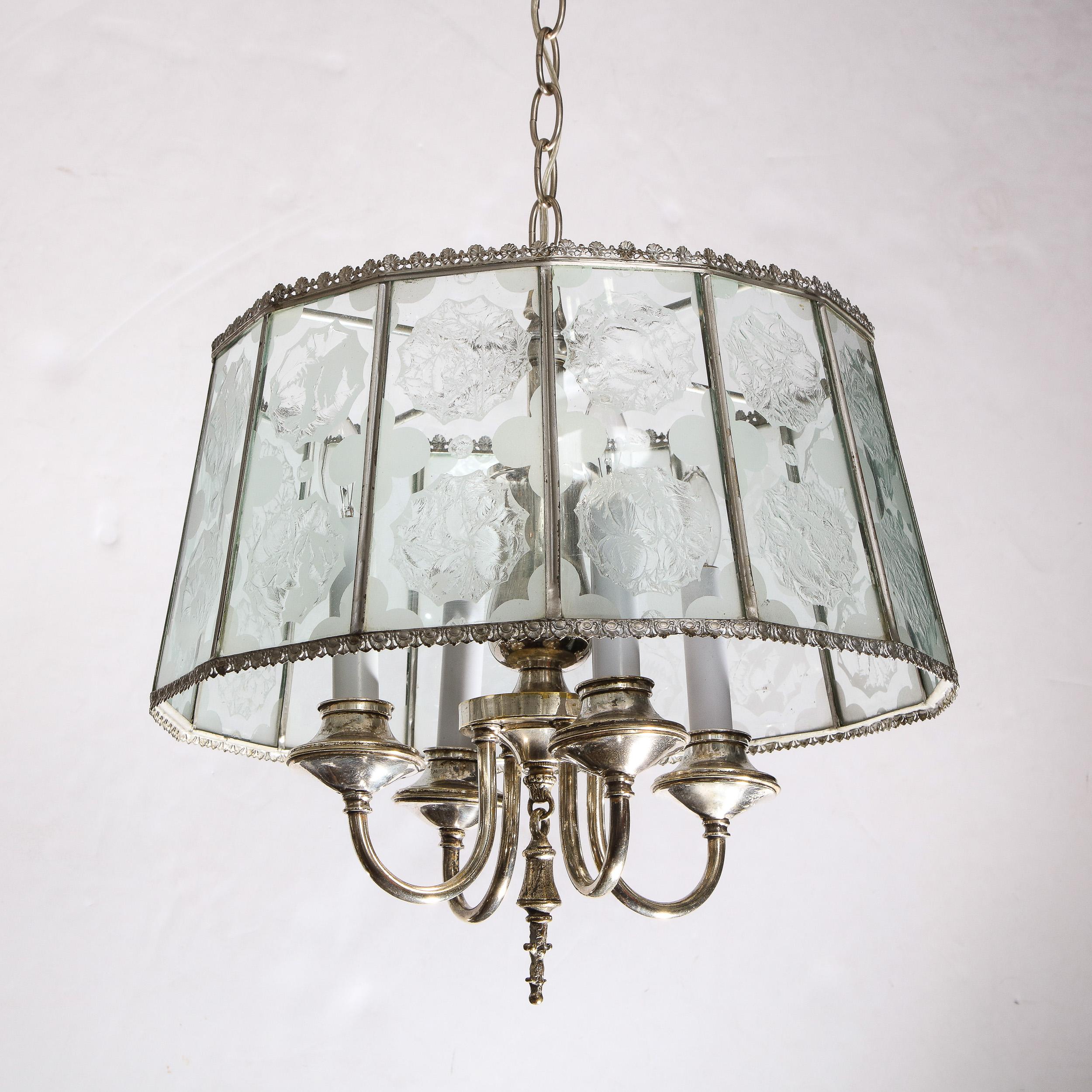 
This beautiful Art Deco revival pendant was realized in the United States, during the latter half of the 20th century. It features a multitude of translucent glass panels replete with a wealth of abstract textured glass embellishments as well as
