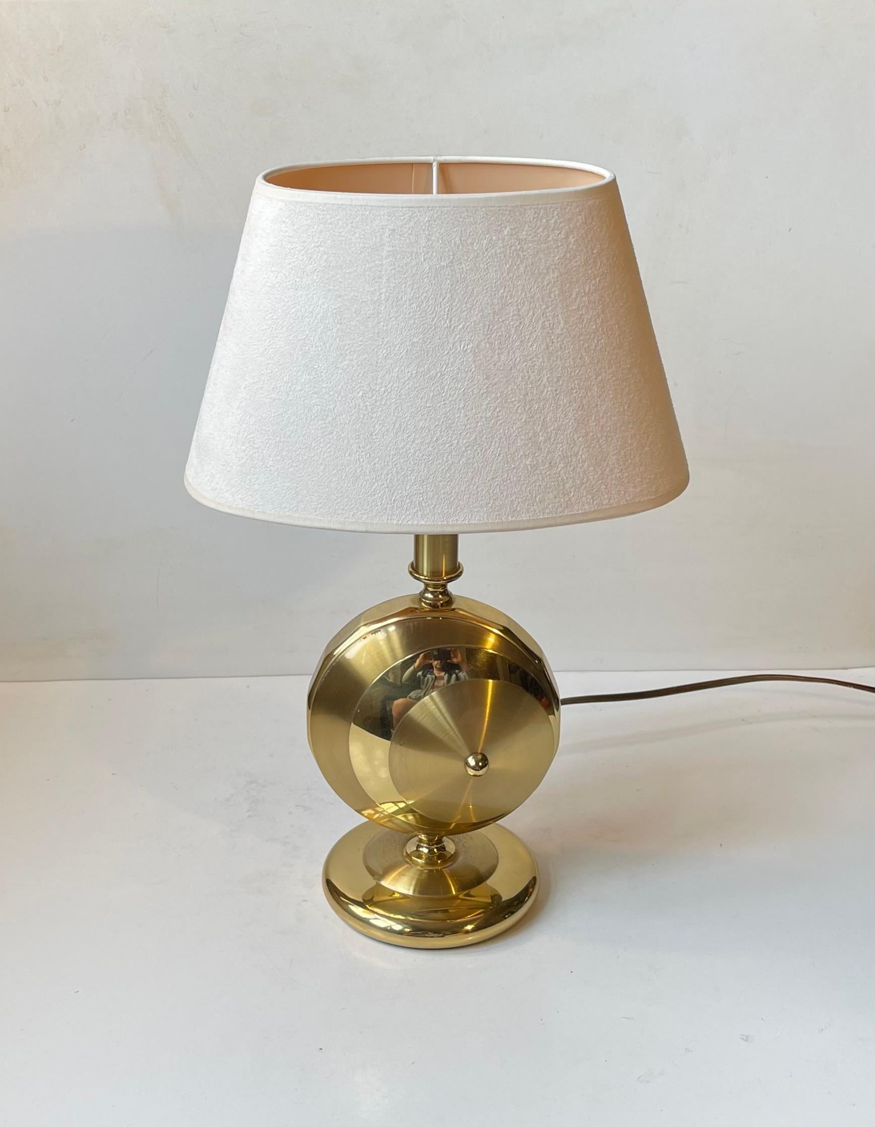 Sculptural table light with base in solid brass - partially polished, partially brushed. This particular model was made to fit on a mantle shelf or indoor window sill. It is wide but with a shallow dept. Practical on/of switch to its socket. Its