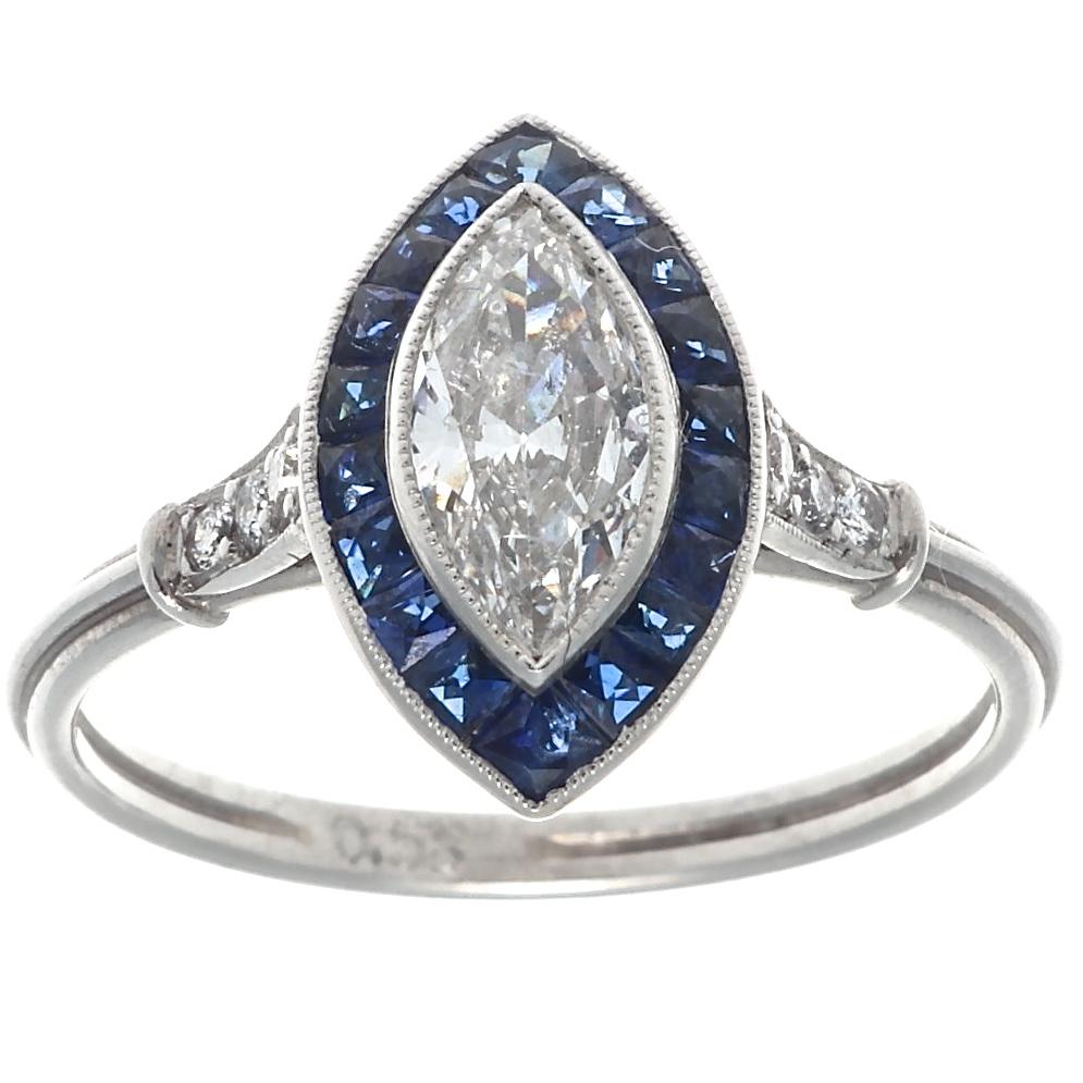 Beautiful Art Deco Style ring featuring a 0.58 carat marquise cut diamond with approximately F-G color, SI2 clarity. With 18 French cut sapphires weighing approximately 0.90 carats and six old European cut diamonds that weigh approximately 0.09