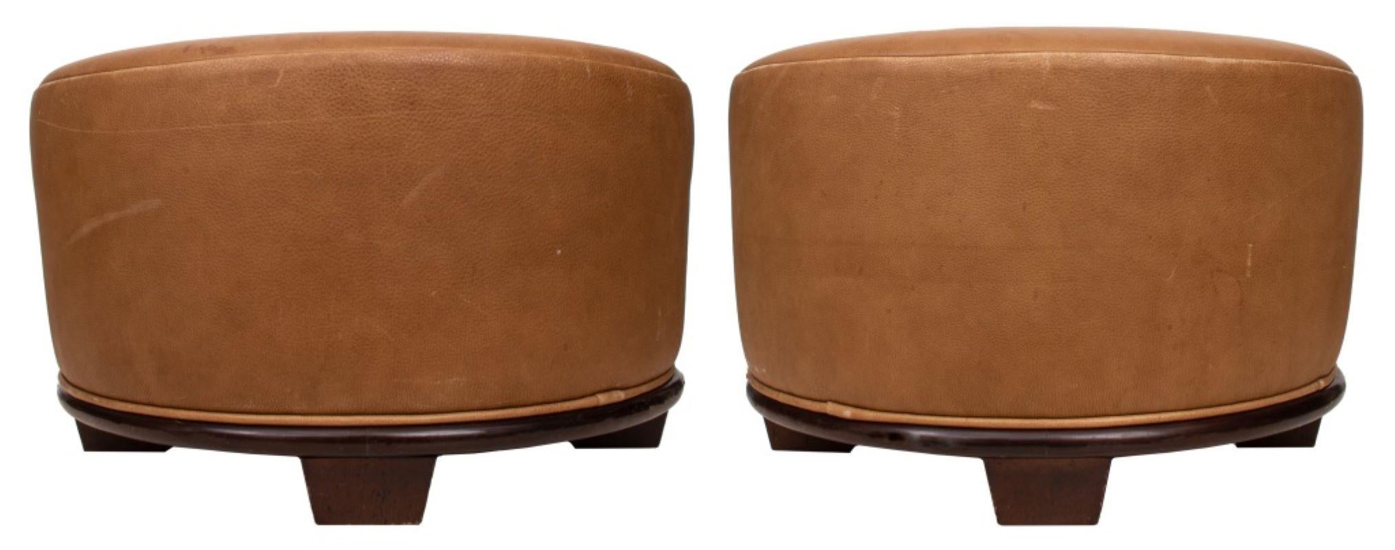 Pair of Art Deco Revival Modern round ottoman stools with brown leather upholstery and hardwood bases, each mounted on four caster wheels. 15