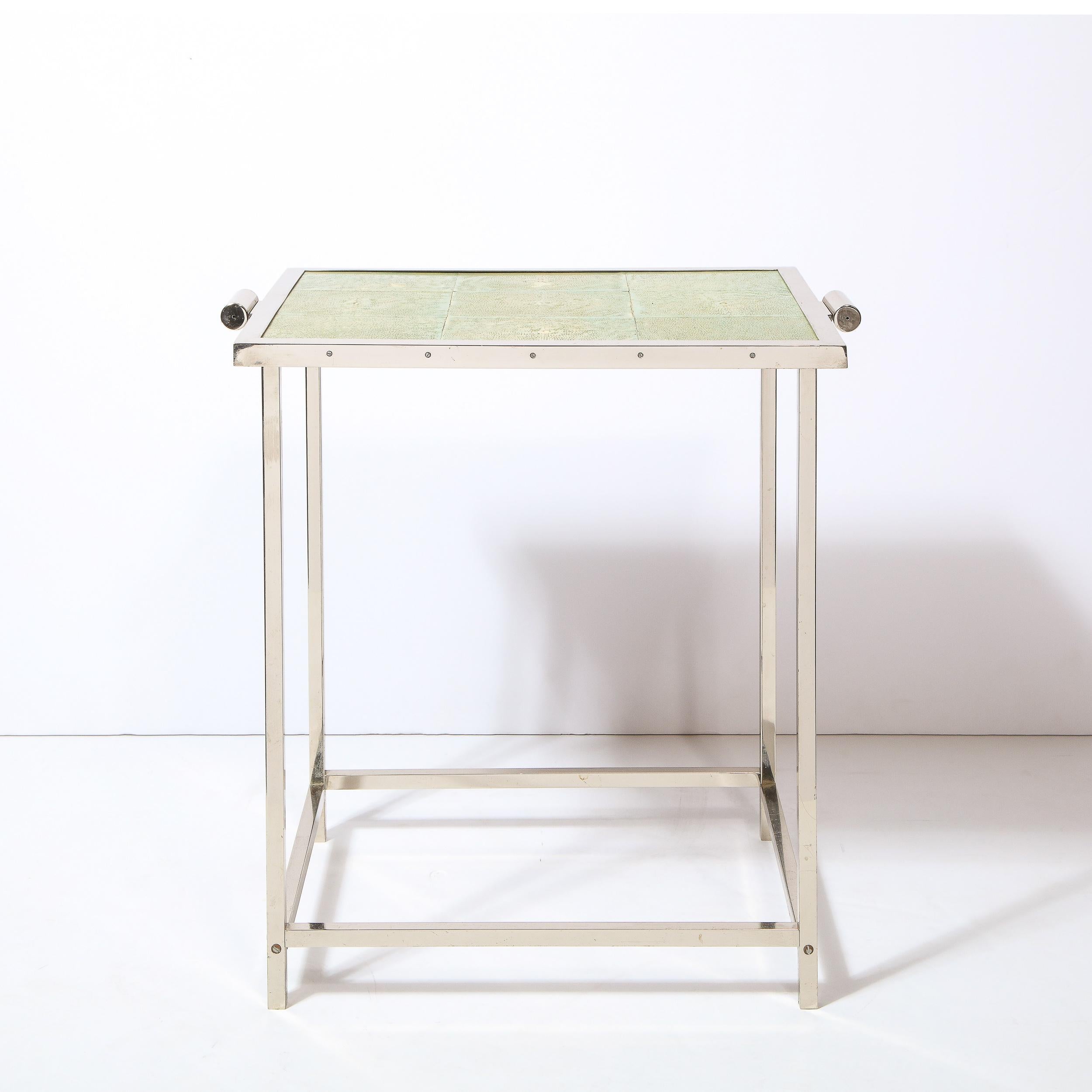 This stunning modernist Art Deco revival table was realized in the United States circa 1980. It features a rectilinear aluminum base with streamlined embellishments on two of the sides and a tessellated shagreen top in a sophisticated jade hue. With