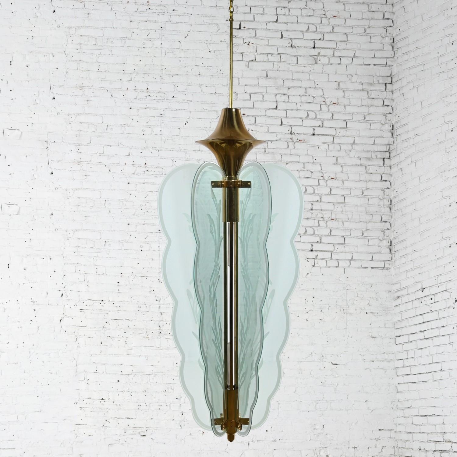Magnificent vintage Art Deco Revival monumental hanging light fixture or chandelier comprised of six glass “wing” panels with etched details, brass ferrule, shaft, brackets, and a new brass canopy. Beautiful condition, keeping in mind that this is