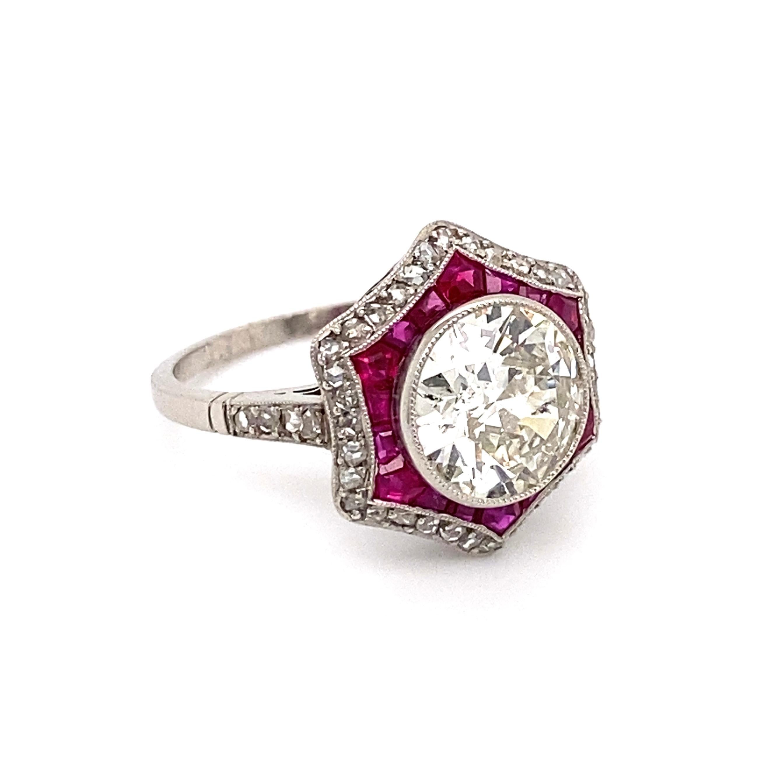 Simply Beautiful! Finely detailed Art Deco Revival Platinum Cocktail Ring, center securely nestled with an Old European Round Diamond, approx. 2.46 Carat, K color, SI2 clarity, surrounded by calibrated Rubies, approx. 1.00tcw and Diamonds, approx.