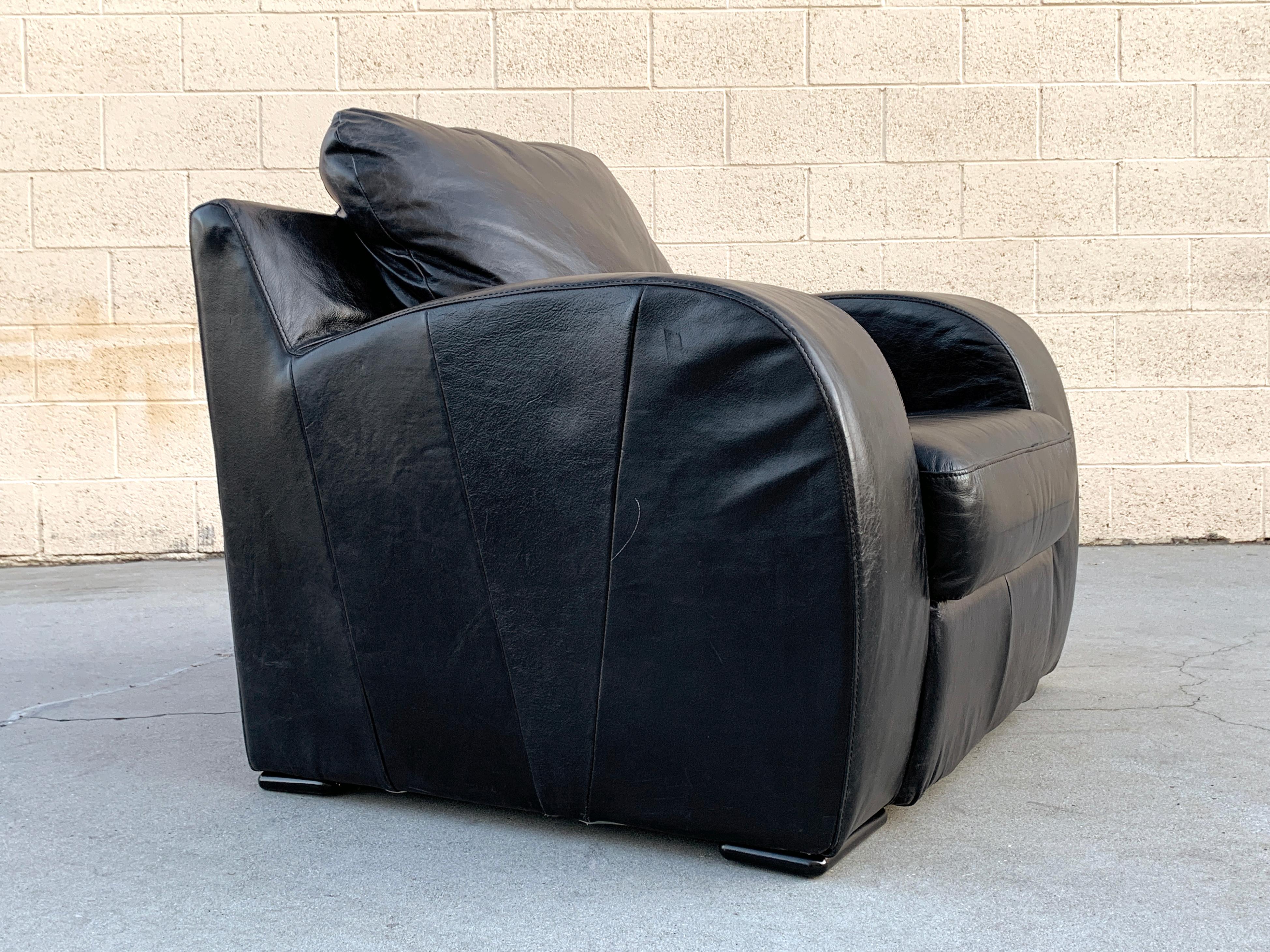 Art Deco Revival leather club chair, circa 1980s. Oversized and extra plush seat with original supple black leather and wonderful streamline moderne styling. It's good looking and undeniably comfortable! Overall in good vintage condition; leather