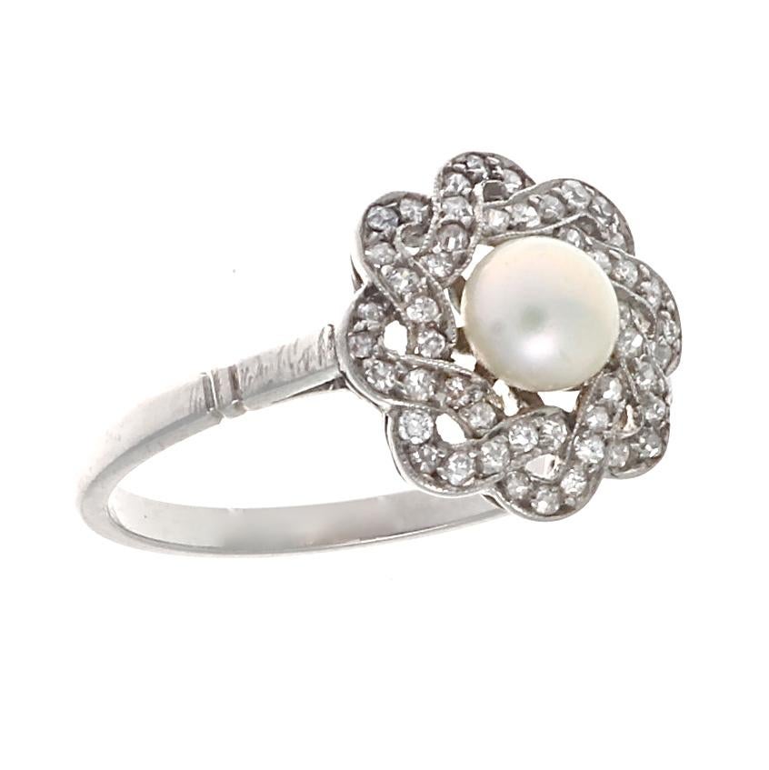 An elegant ring featuring a lustrous pearl surrounded by well matched sparkling white diamonds. Crafted in platinum. Ring size 9 and can easily be resized to fit, if needed this would come complimentary with your purchase.