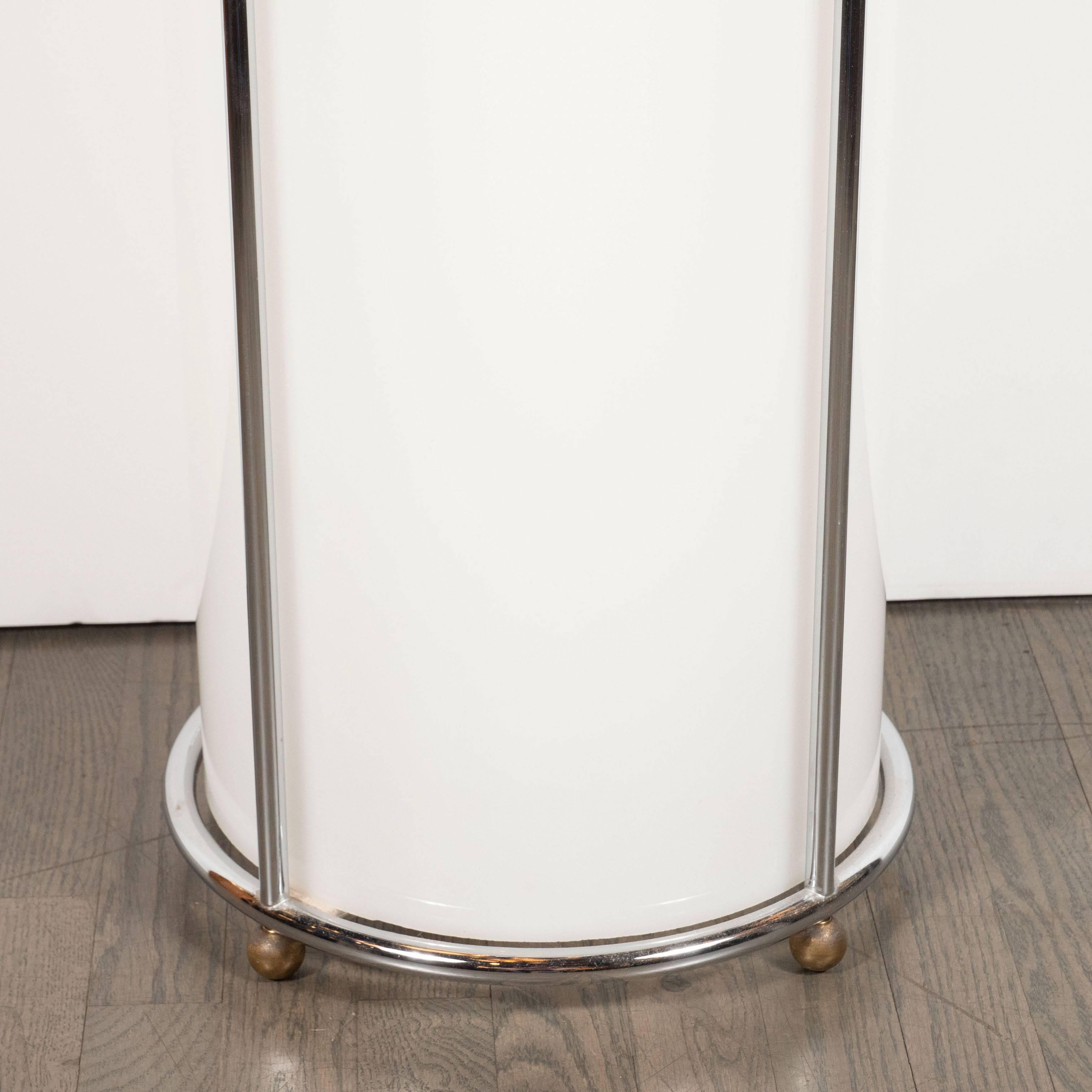 This gorgeous Art Deco pedestal offers a cylindrical opaque white plexi body with a circular polished chrome wrapped base and top, as well as spherical ball feet, also in chrome. Cylindrical chrome supports connect the base and the top, creating a