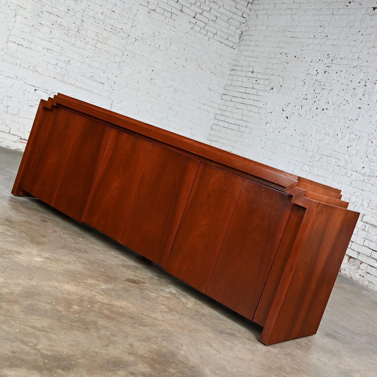 Stunning vintage Art Deco Revival to Postmodern custom step-down credenza, sideboard, buffet, or cabinet comprised of mahogany with 3 sets of double doors, push latches, and an adjustable single shelf behind each section. Beautiful condition,