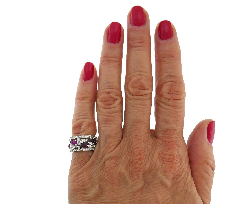 Lovely Art Deco Style Tutti-Frutti band ring.
Made of platinum set with carved ruby and Old European, single and baguette cut diamonds. Ruby total weight approximately 2.0 carats. The diamonds are I-J color, VS clarity, total weight approximately