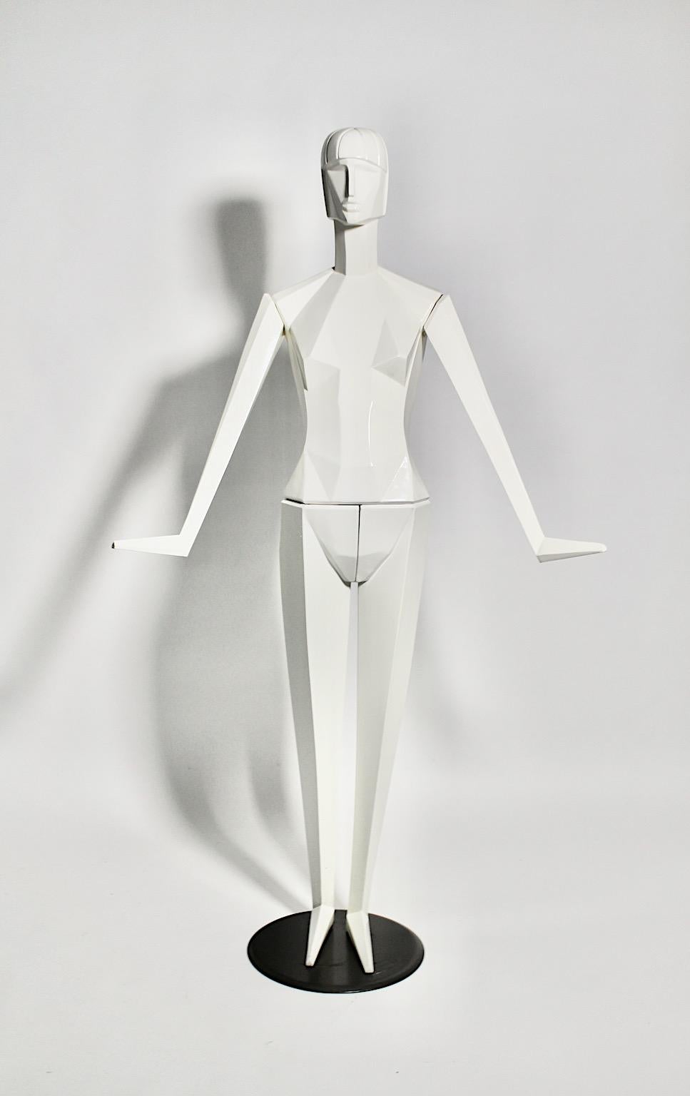 Art Deco Revival white full body vintage plastic mannequin, which was designed and manufactured, 1980s, France.
The mannequin shows geometric and cubism inspired features. The body with metal connections from polyester and white coated wood stands