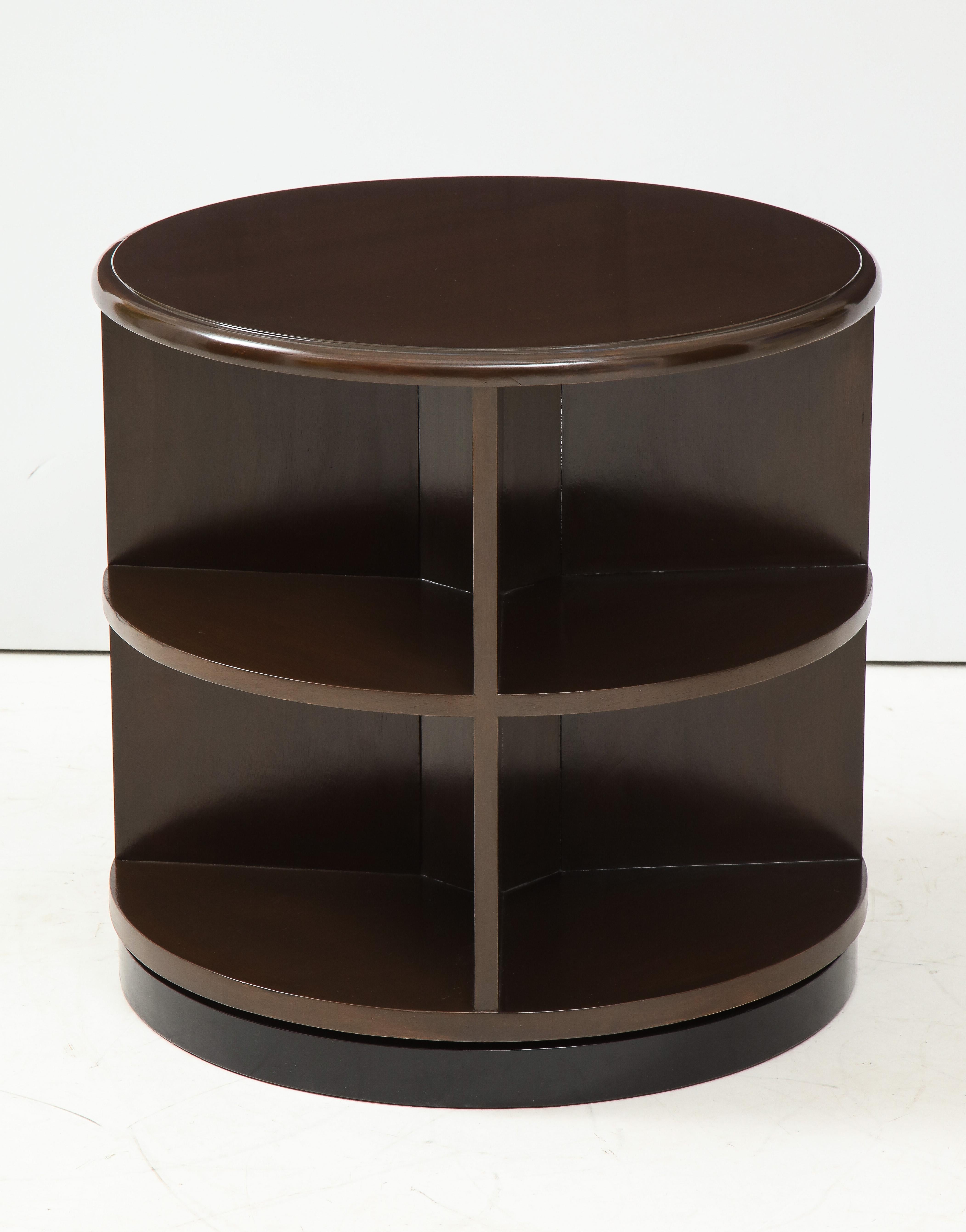 Pair of bespoke revolving Art Deco walnut side tables in a chocolate brown stain resting on black lacquer base. 8 sections in each table to house books or curiosities.