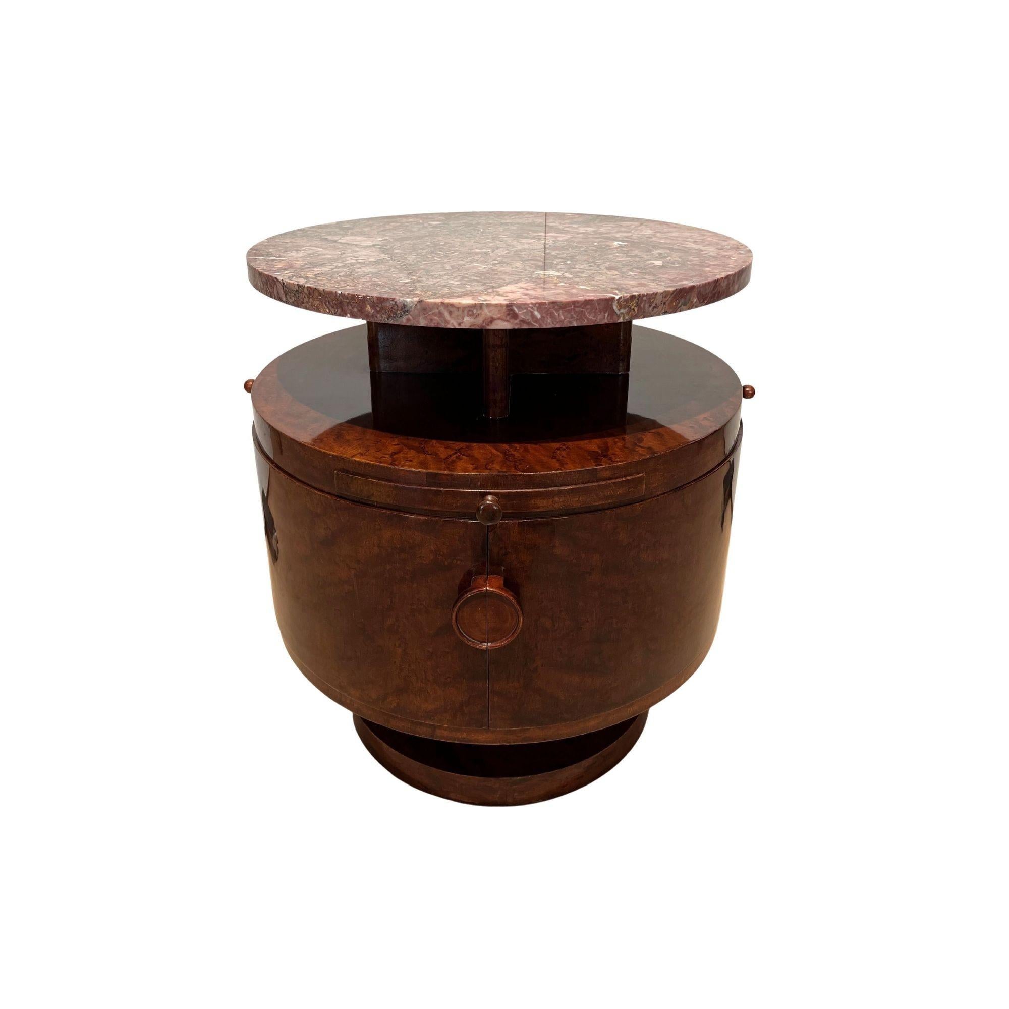 Elegant Art Deco revolving drum table or side table, perfect for adding a touch of luxury and sophistication to any space. This unique table features a round design with birdseye maple veneer that has been originally stained and polished. The table