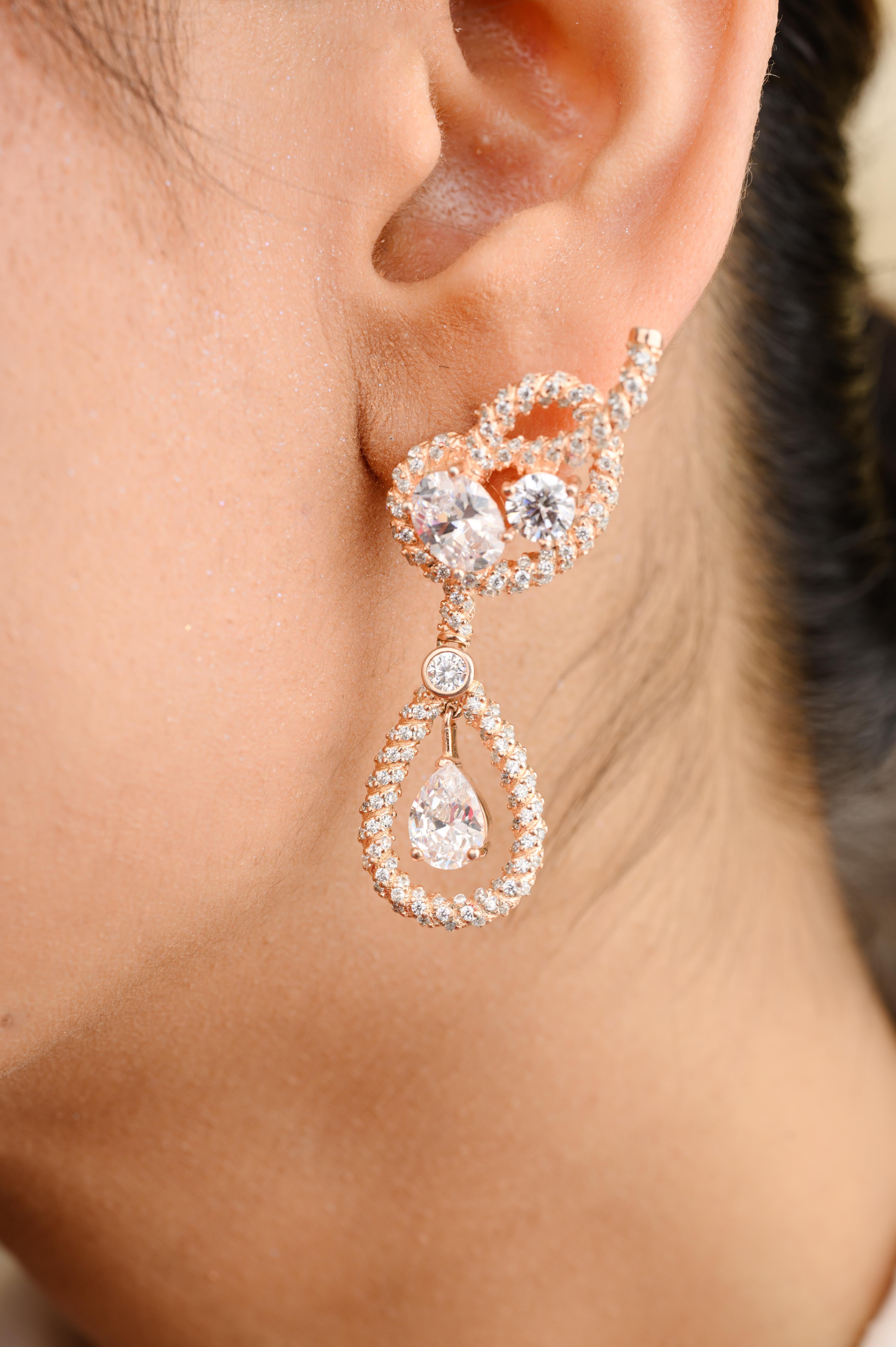 Art Deco Style Rhainstone Dangle Wedding Earrings in sterling silver. You shall need dangle earrings to make a statement with your look. Each piece features dazzling cubic zirconia stones, renowned for their brilliance and clarity, set in