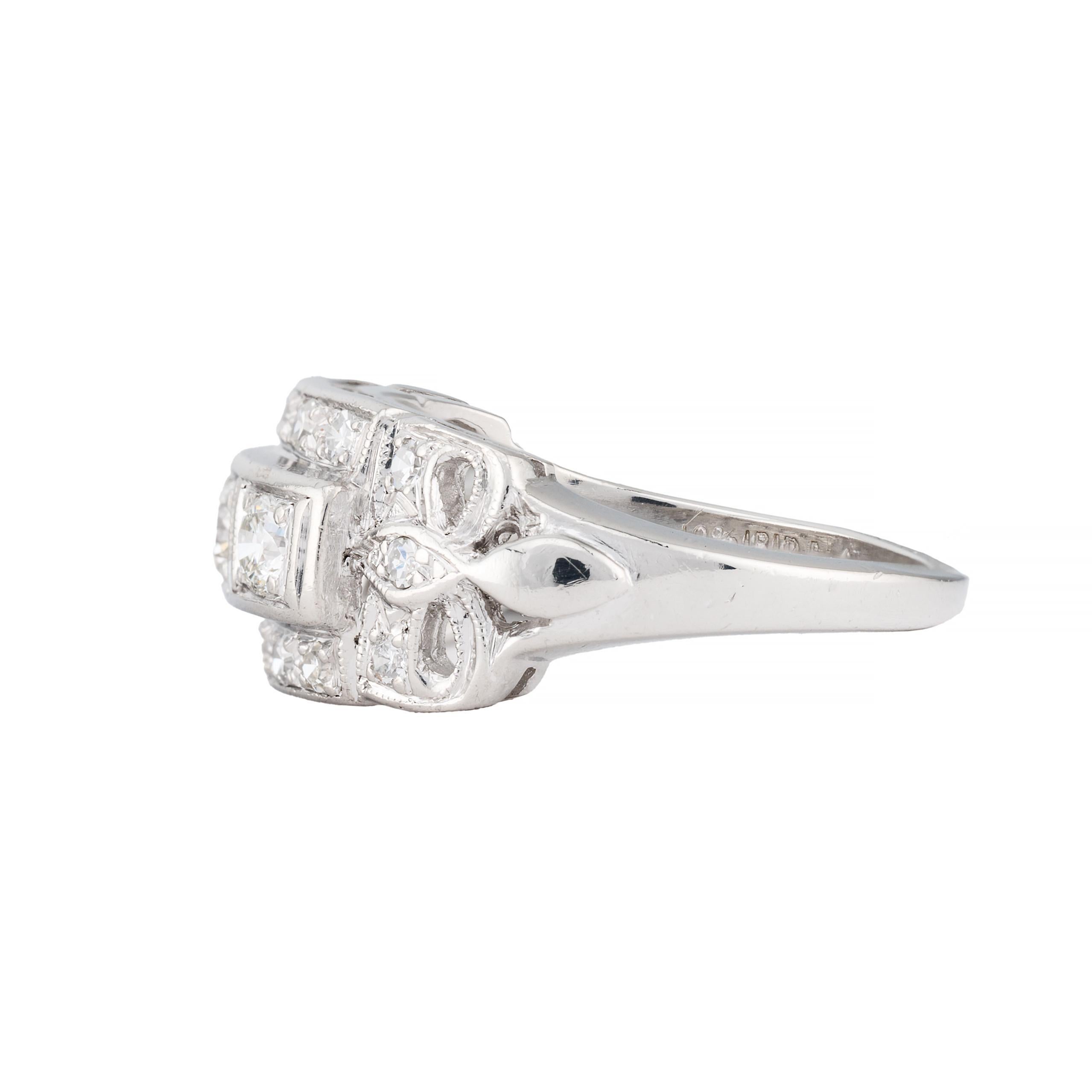 Aston Estate Jewelry Presents:

A sophisticated band ring featuring a trio of European cut diamonds at center of 0.30ctw. Accented by 0.24 carat of pave set round cut diamonds. All diamonds are of VS1 clarity and G color grade.

Crafted in platinum,