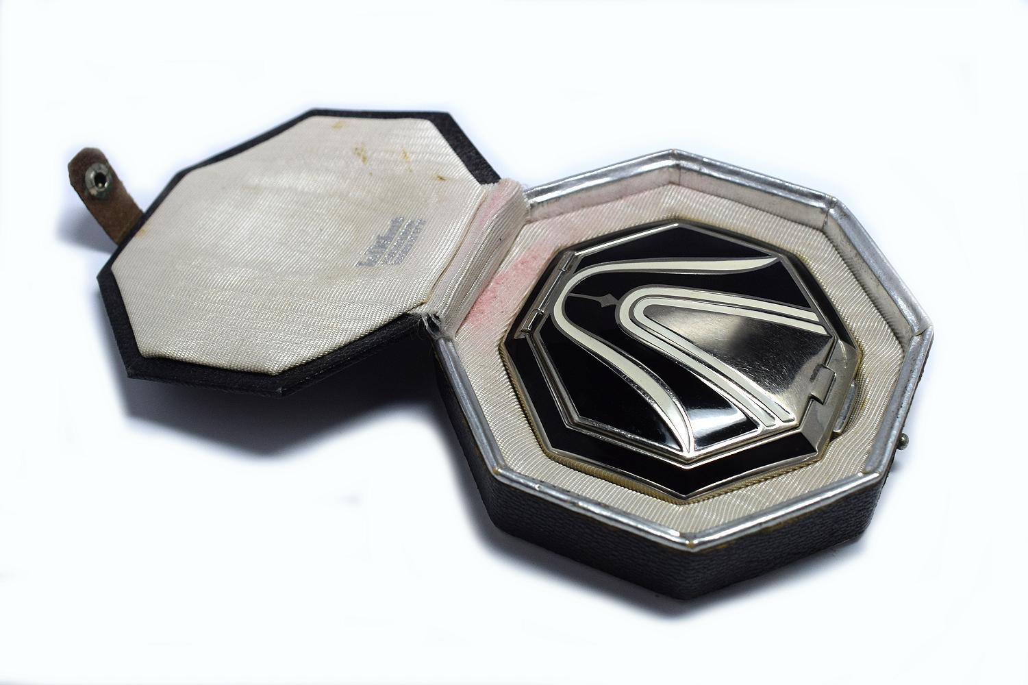 An Art Deco Richard Hudnut Le Debut 'Tulip' compact of octagonal form, with black and ivory colored enamelled decoration, fitted in original black leatherette box with paper label. Designed for Richard Hudnuts Deauville Line, the rouge and makeup