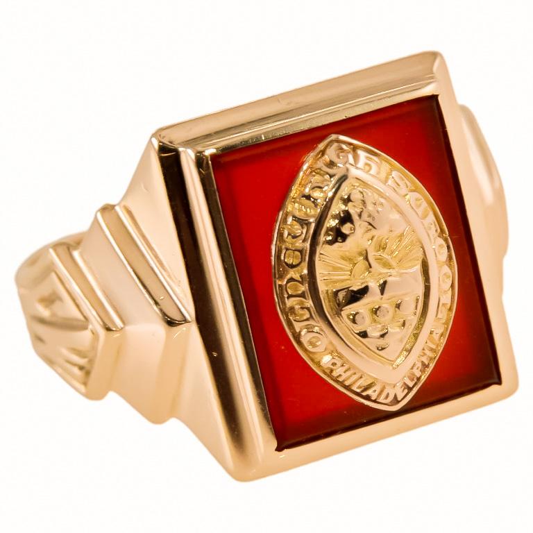 STYLE / REFERENCE: Art Deco Class Ring
METAL / MATERIAL: 10Kt. Yellow Gold 
CIRCA / YEAR: 1941
CENTER STONE: Carnelian
SIZE: 8 UNISEX

One of my favorites from the long lost collection. Crafted in 10K Yellow Gold, this charming class ring is from