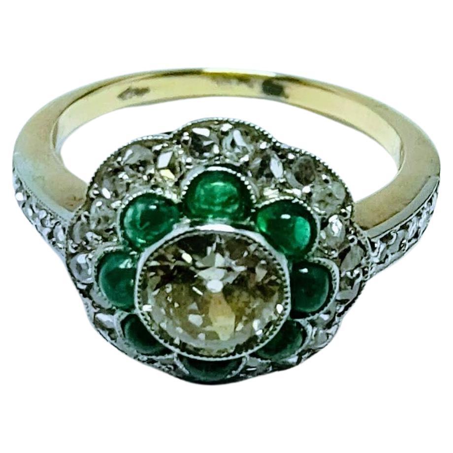 Beautiful Art Deco Ring 1930s flower format made in Yellow gold 18 Karat and seen in Platinum weight 3.91 grams.  Central Diamond 6.75x6.75x2.90 millimeters estimated weight 0.85 carats Clarity I1 and Color K-L .8 Emeralds in the form of a half moon