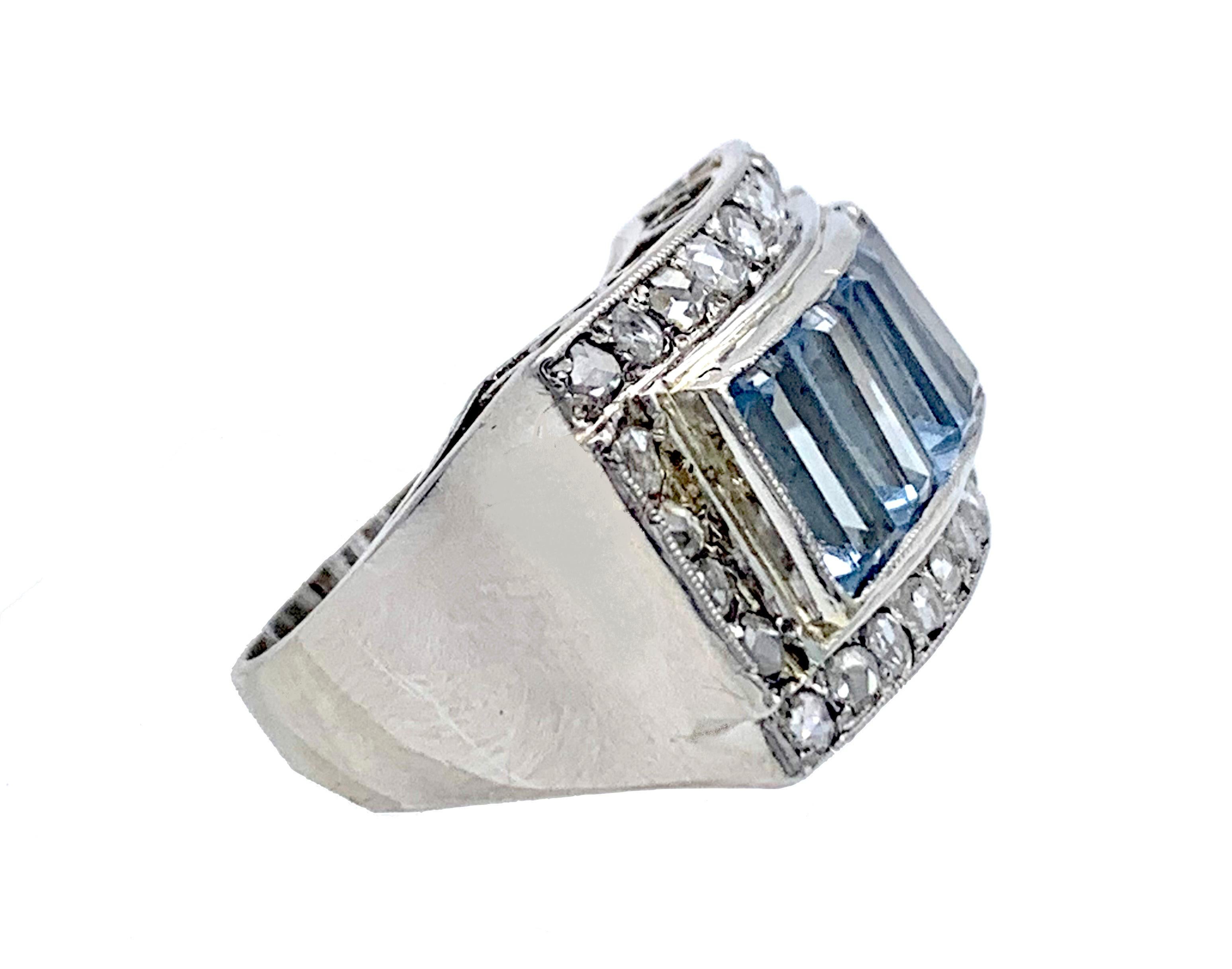 This ring was hand crafted out od 18 karat white gold in the 1930. Four baguette cut aquamarines are surrounded by 26 old mine rose cut diamonds mounted in mille griffe settings. The ring galleries are decorated with an elegant pierced ornament The
