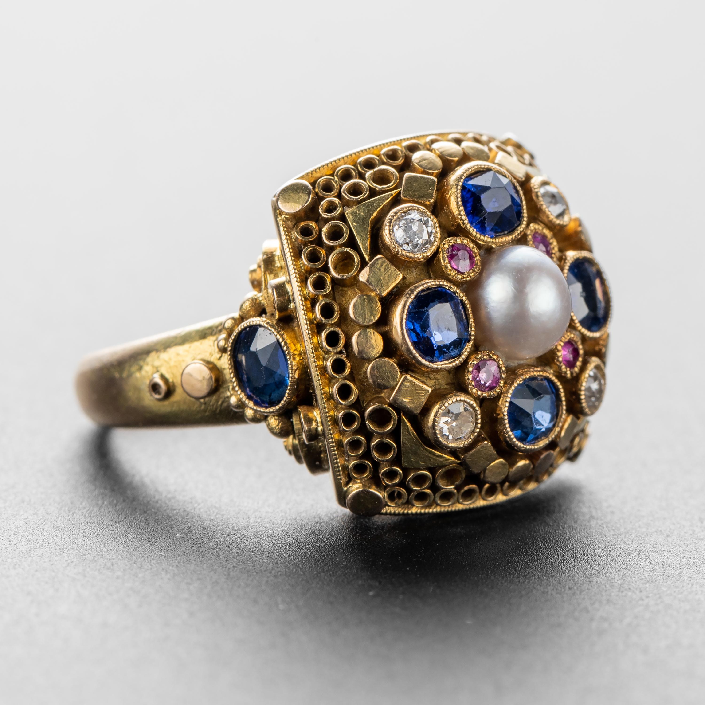 This original Elmar Seidler ring is composed of high-karat gold (at least 18K) that has been intricately and meticulously worked by Seidler to create a ring that defies categorization. Small geometric forms adorn the face of the ring, granulation