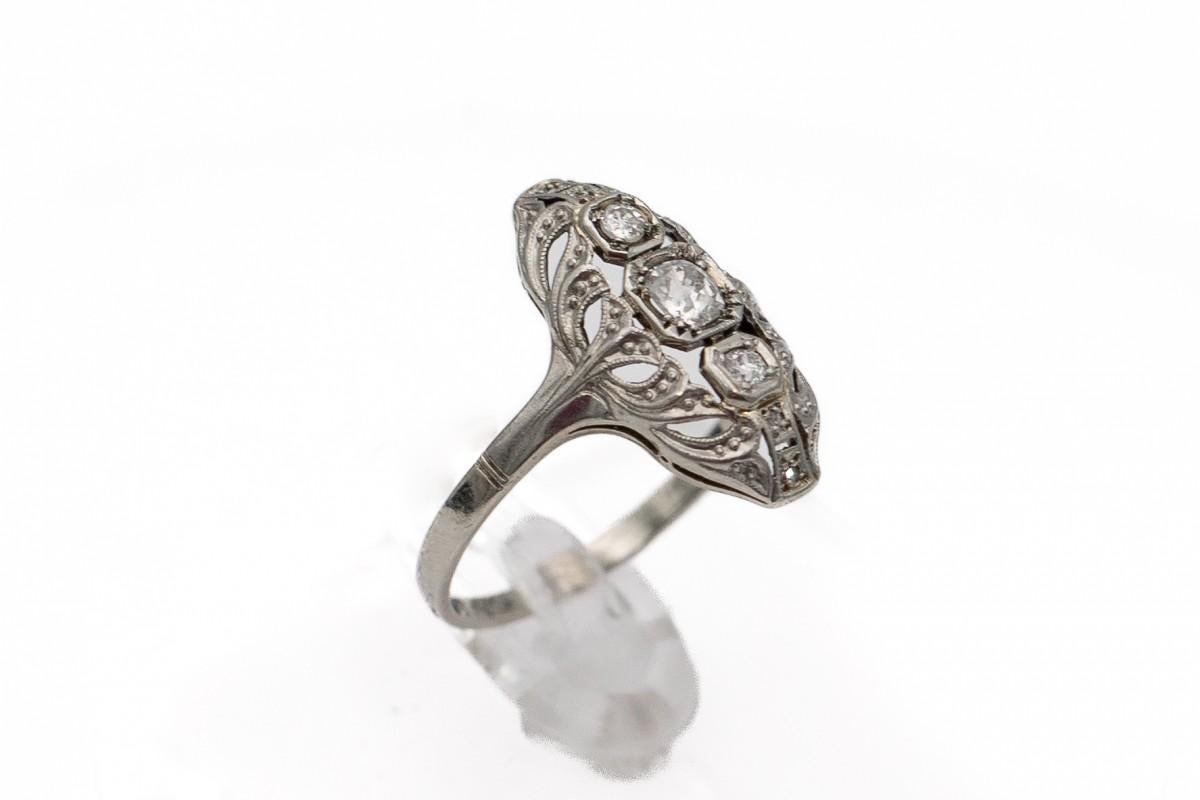 A beautiful old Art Deco ring made of 14-carat white gold.

Set with five old-cut diamonds.

Central diamond weighing approx. 0.24ct (color H, clarity VS1)

Year: around 1930.

Ring size: 16 - size can be adjusted

The purchase is accompanied by a