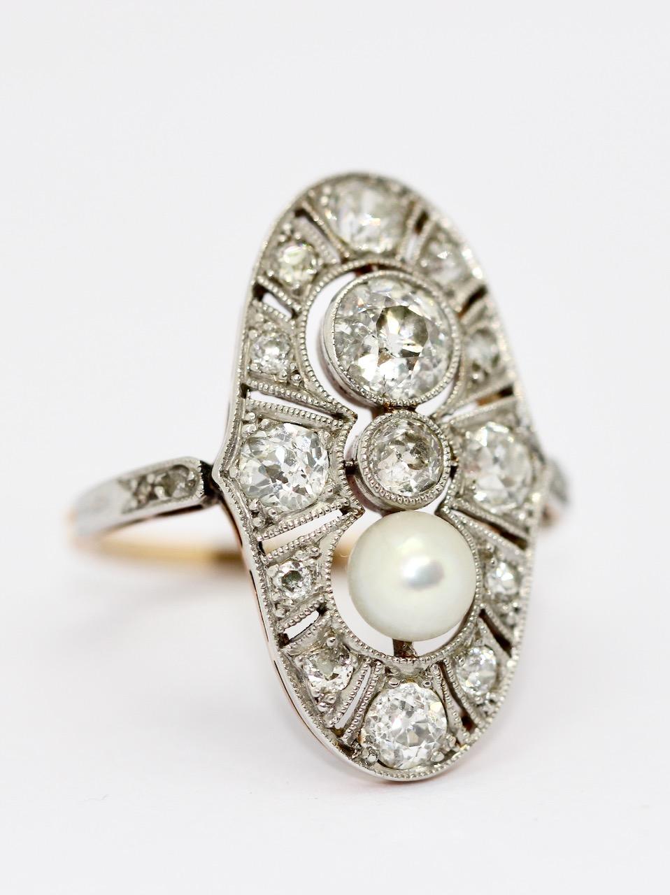 Charming Art Deco ring, red gold and platinum, set with diamonds and natural pearl.

The large diamond has a size of approx. 0.7 carat
The pearl has a diameter of approx. 5.2 mm

Dimensions ring head: 25.2mm x 14.4mm

Includes certificate of