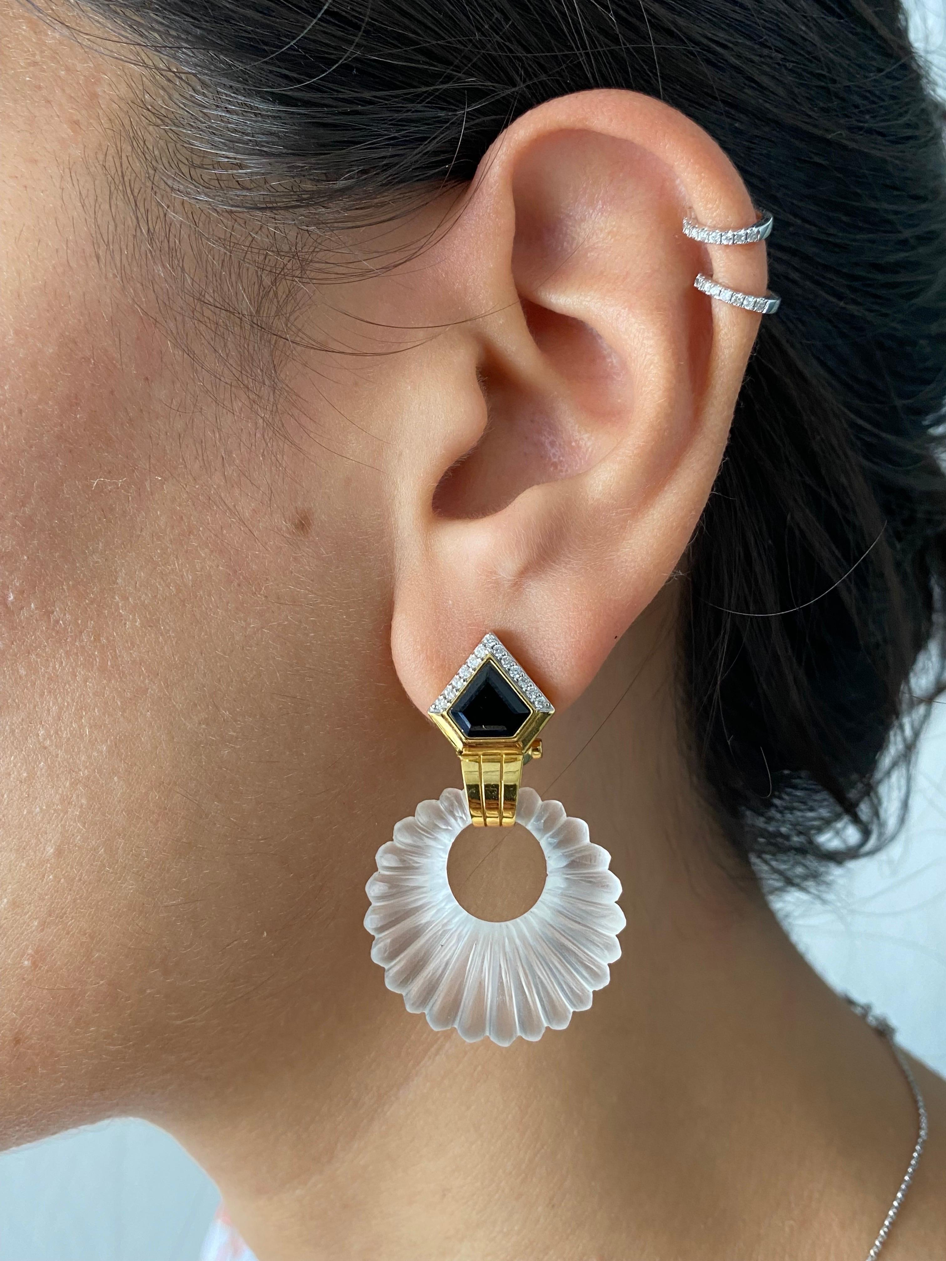 A beautiful art-deco inspired pair of dangle earrings, with custom cut carved rock crystal and black onyx and white diamonds, set in 18K yellow gold. The earrings come an omega clip. 
Please feel free to message us for more information. 
We provide