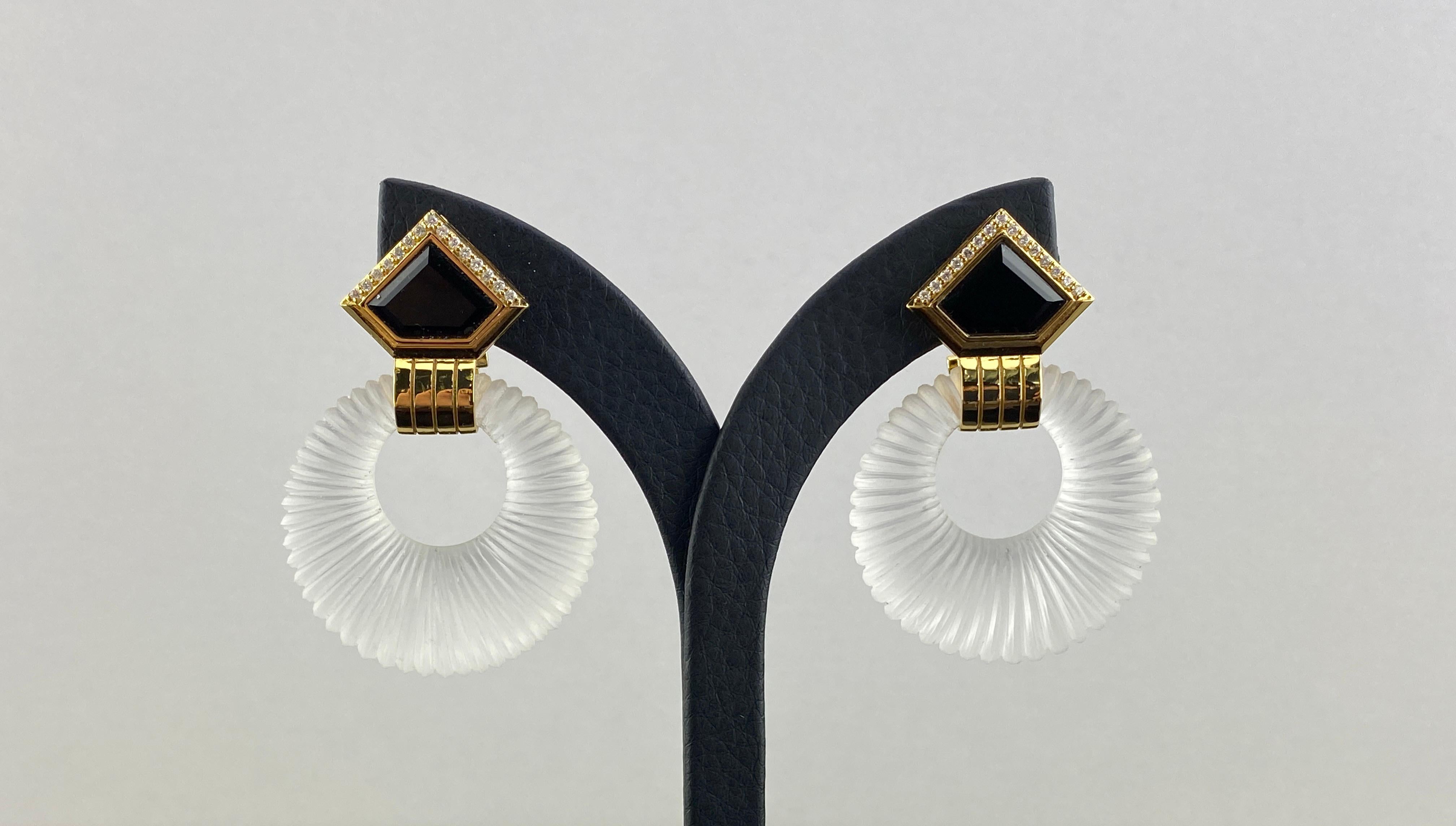 Make a statement with this pair of stylish, art-deco inspired Rock Crystal and Black Onyx earrings with White Diamonds studded in solid 18K Yellow Gold. These earrings come with an omega backing, which gives the earrings more support.
We offer free