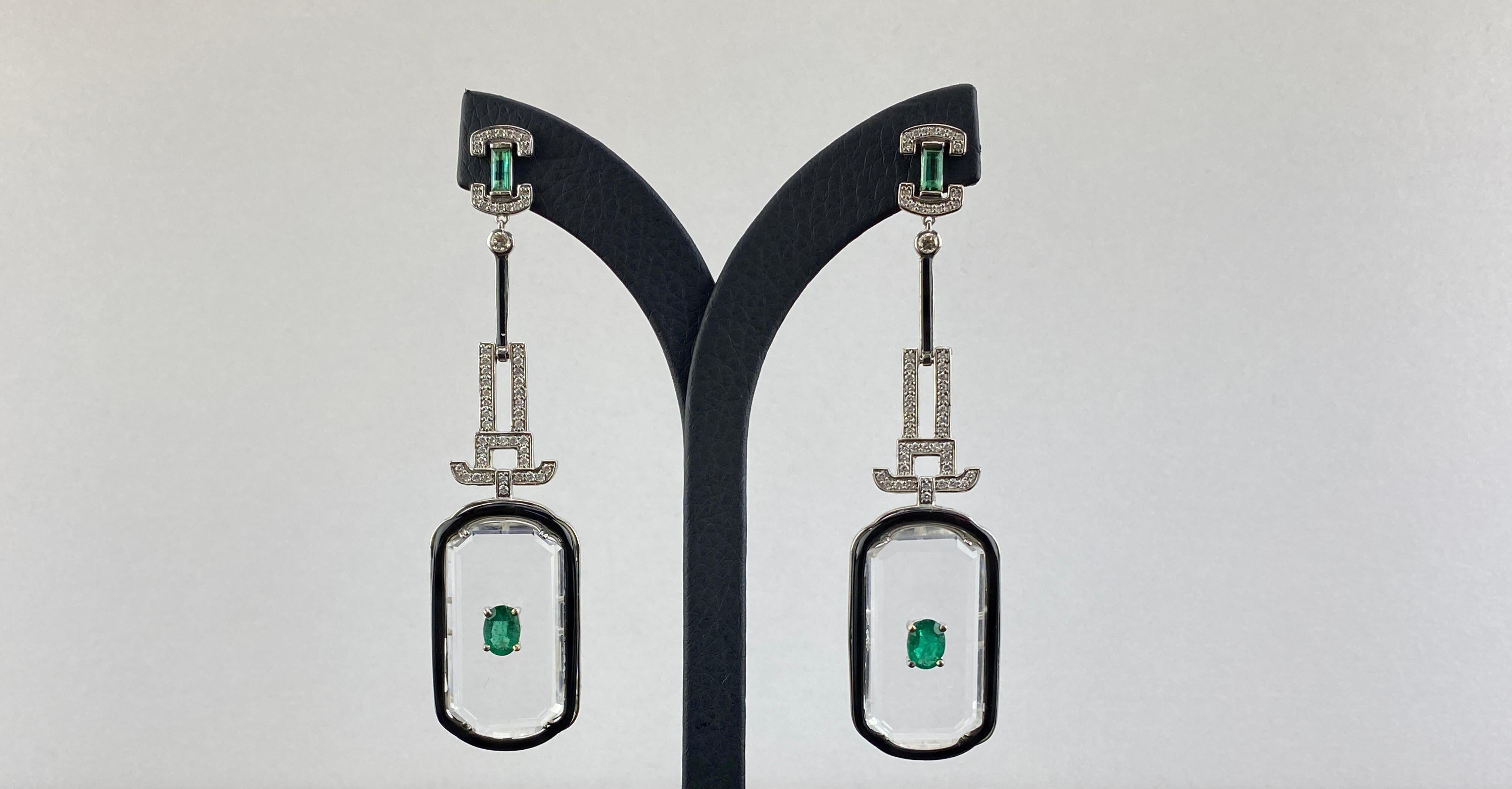 A carefully crafted 3 carat Zambian Emerald studded Rock Crystal dangle earrings, with White Diamonds and Black Onyx, all set in solid 18K White Gold. This is classic replica of jewels from the art deco era. The earrings are around 3 inches long,