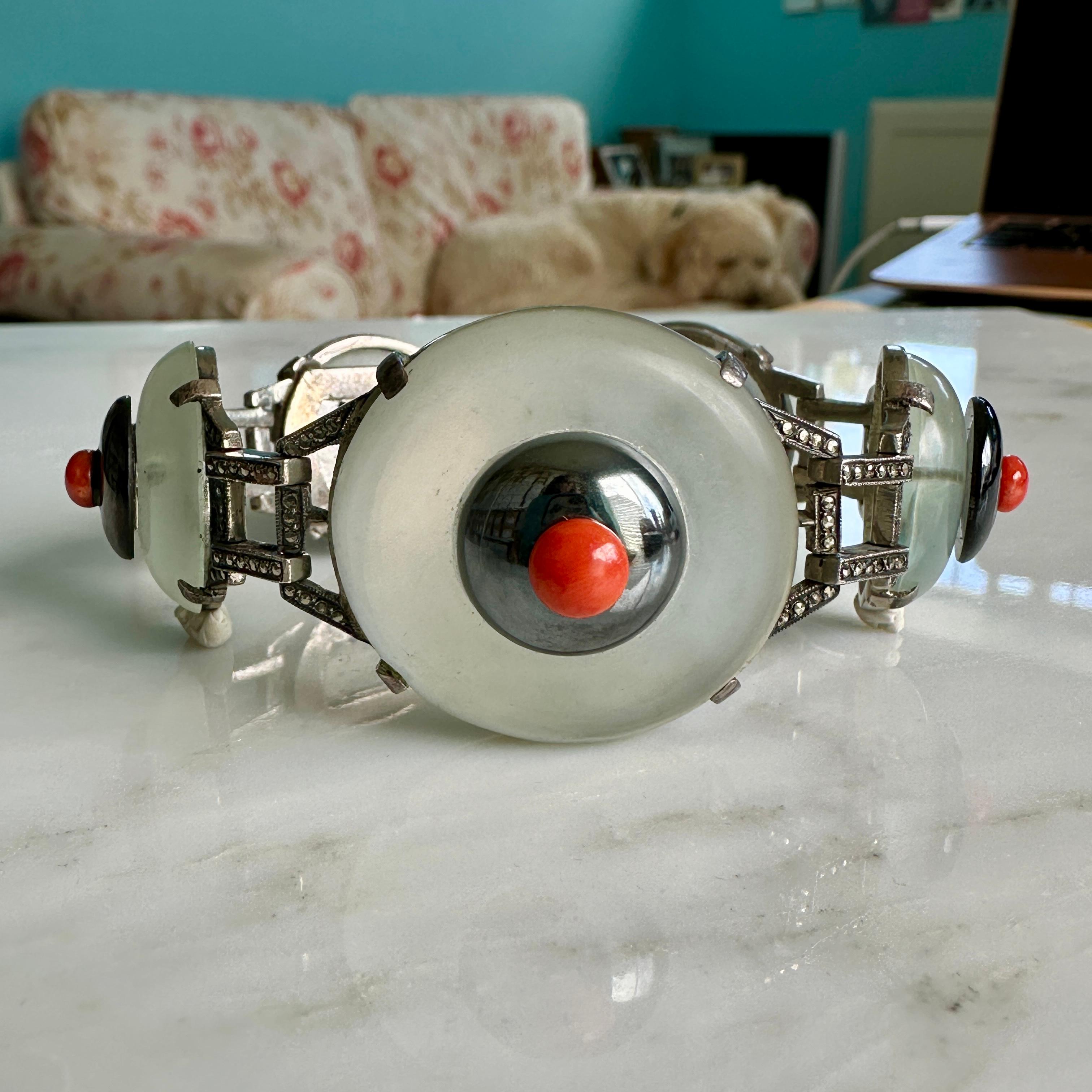Details:
An RARE antique Art Deco beauty! Truly stunning 1920's Art Deco rock crystal, hematite, red coral, marcasite and silver bracelet. It is a really unique piece! This piece has a nice weight to it, with 5 carved rock crystal half orbs prong
