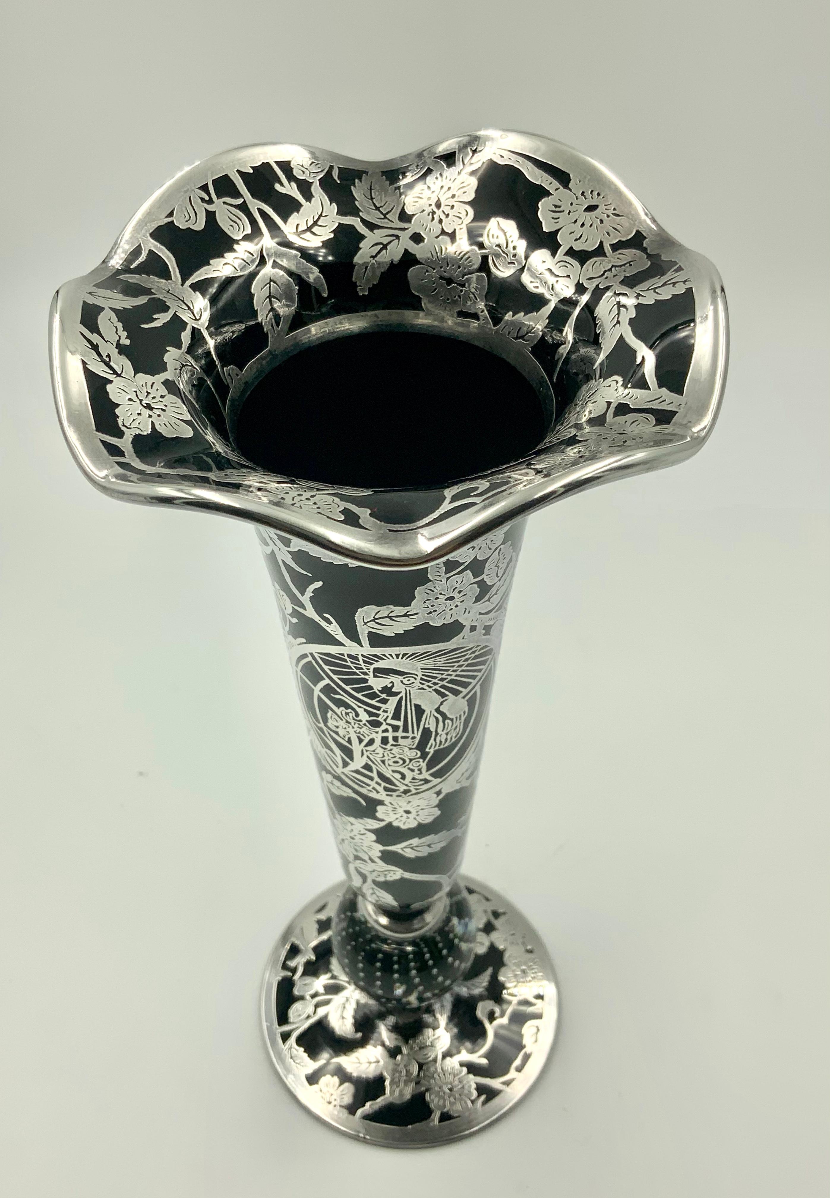 A extraordinary piece created by a collaboration of Rockwell Silver Company and pairpoint glass. This beautiful black amethyst glass vase has the traditional Pairpoint bubble glass base and a gorgeous ruffled trumpet. To make the piece even more