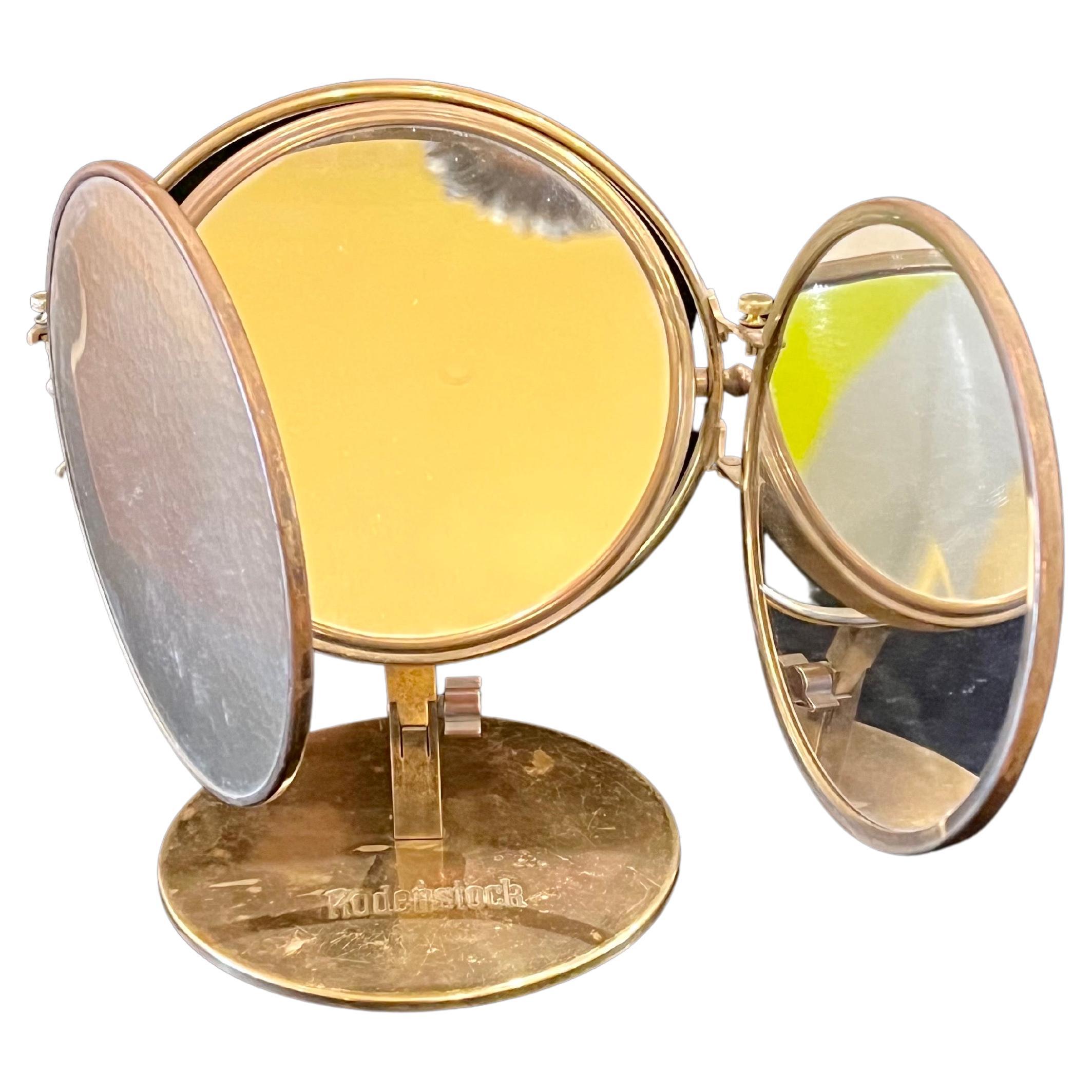 Beautiful multidirectional triple brass optometry mirror, circa 1940s in patinated brass from Rodenstock store in Germany.